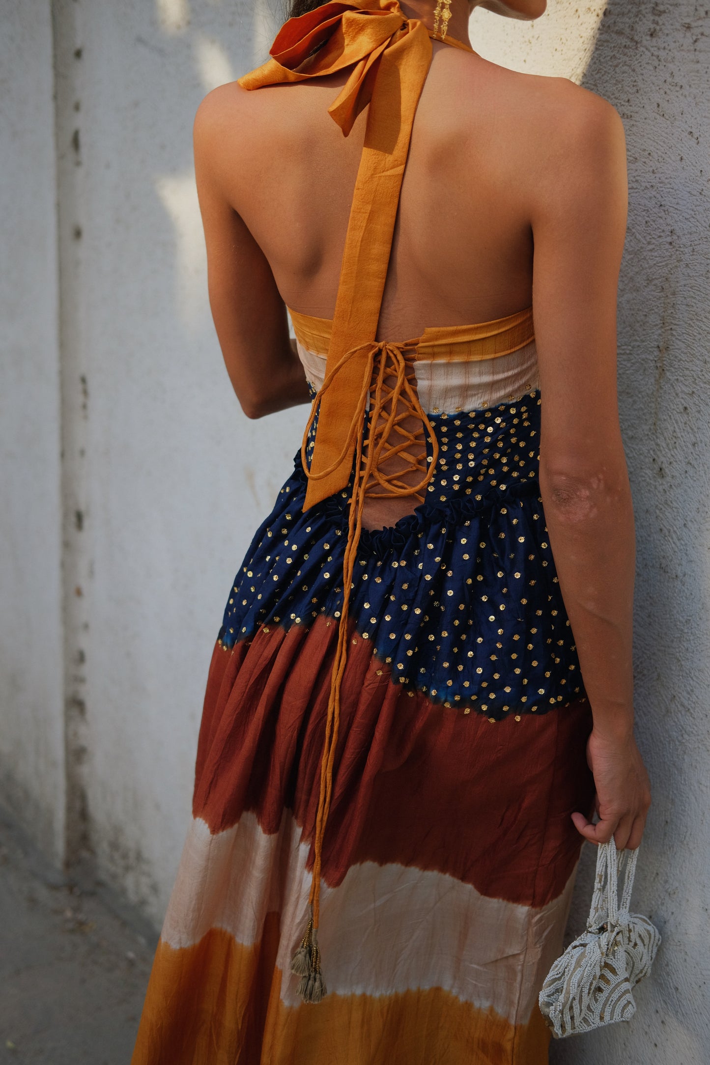 
                  
                    Aarohi Dress Maxi in Twilight – Handwoven mulberry silk Shibori gown with brass sequin embellishments and halter neck, handcrafted by Kumbaya artisans in India
                  
                