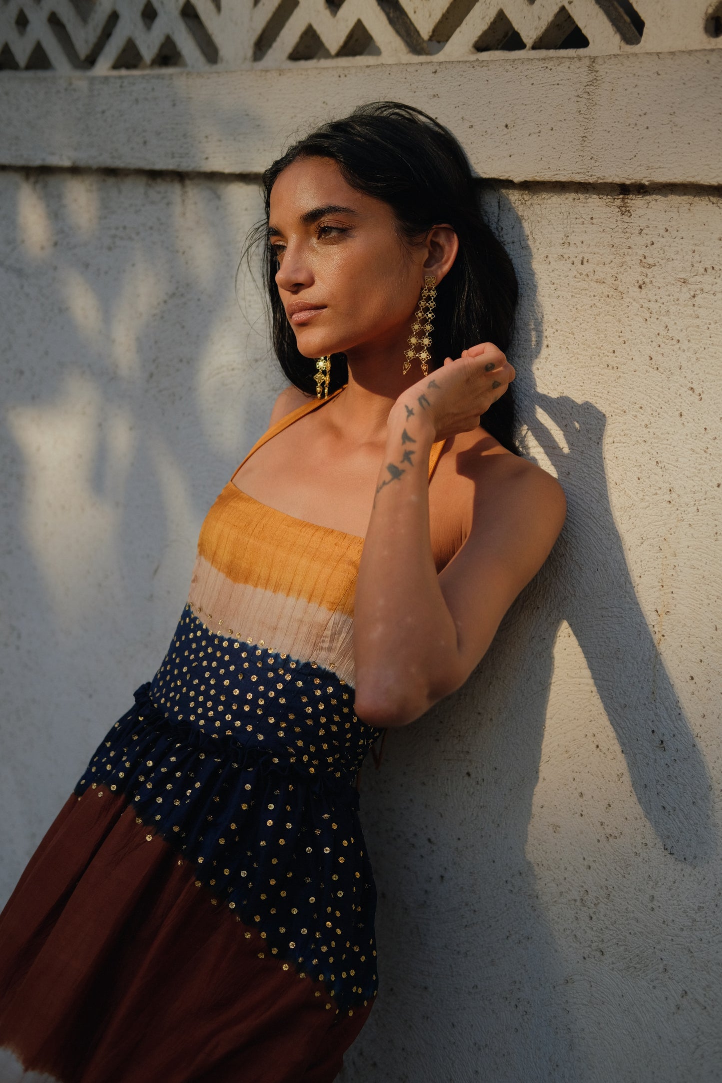 
                  
                    Aarohi Dress Maxi in Twilight – Handwoven mulberry silk Shibori gown with brass sequin embellishments and halter neck, handcrafted by Kumbaya artisans in India
                  
                