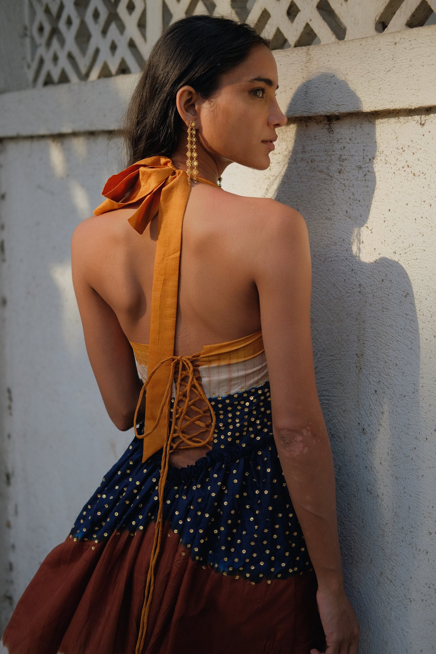 
                  
                    Aarohi Dress Maxi in Twilight – Handwoven mulberry silk Shibori gown with brass sequin embellishments and halter neck, handcrafted by Kumbaya artisans in India
                  
                