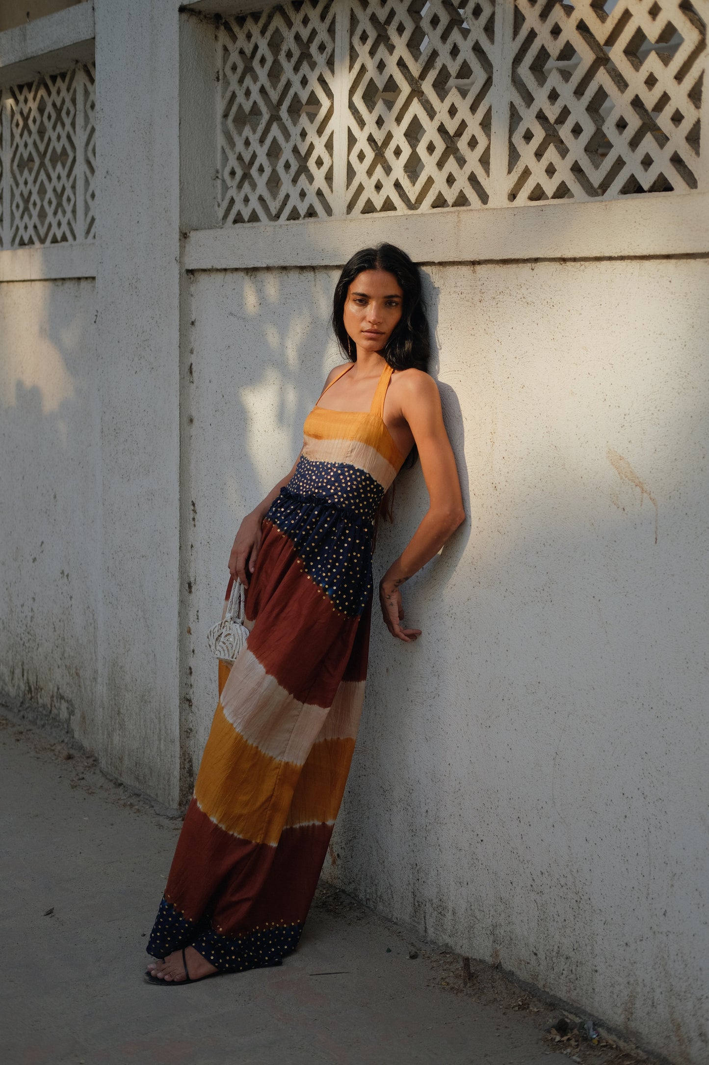
                  
                    Aarohi Dress Maxi in Twilight – Handwoven mulberry silk Shibori gown with brass sequin embellishments and halter neck, handcrafted by Kumbaya artisans in India
                  
                