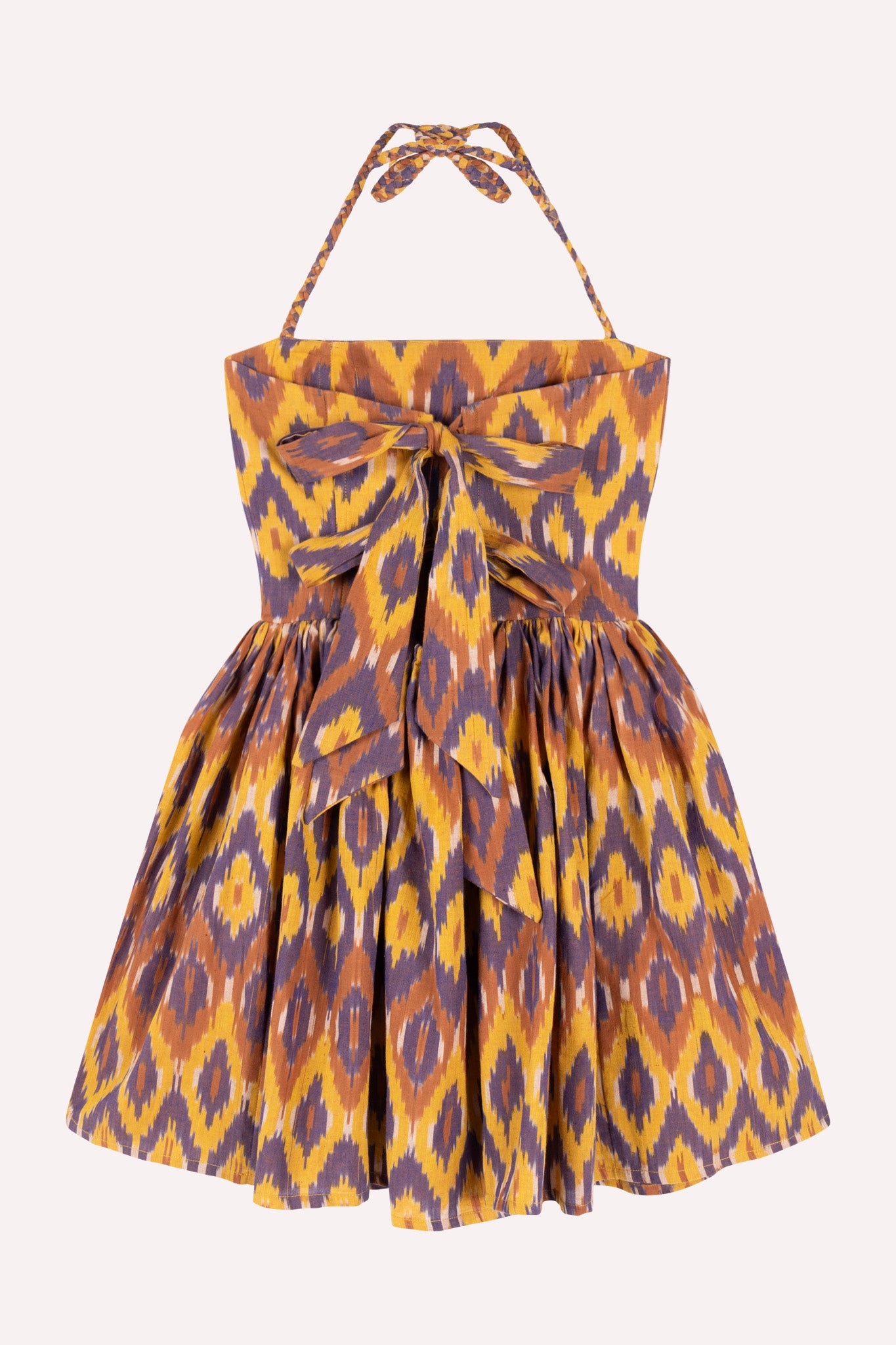 A sleeveless knee-length dress with geometric Ikat pattern, spaghetti straps, and a fitted bodice.
