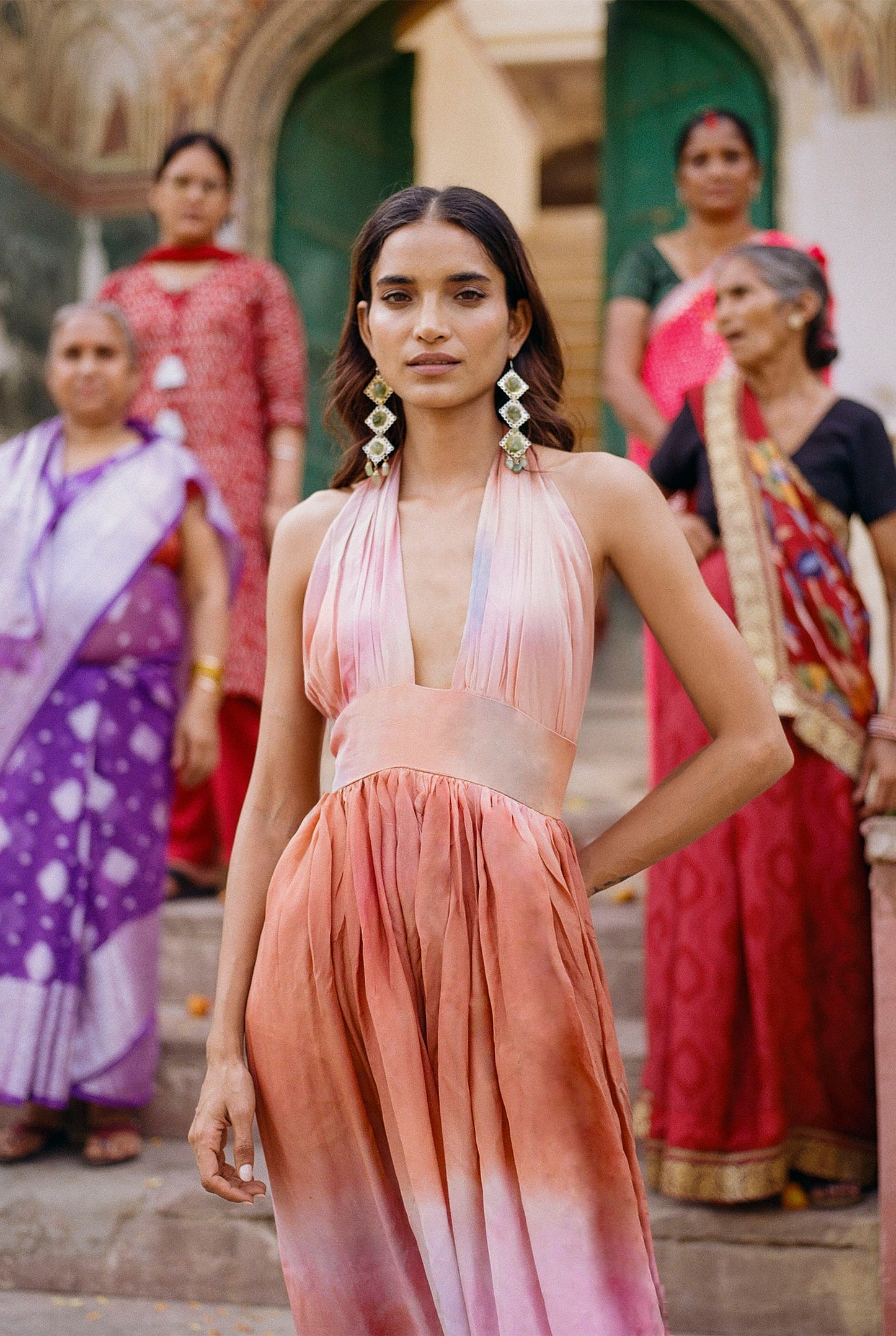 
                  
                    ZAZI Holiya hand-dyed maxi dress with halter neckline, flowing silhouette, and sunset-inspired watercolor hues, handcrafted in India by Heenaagrima artisans.
                  
                