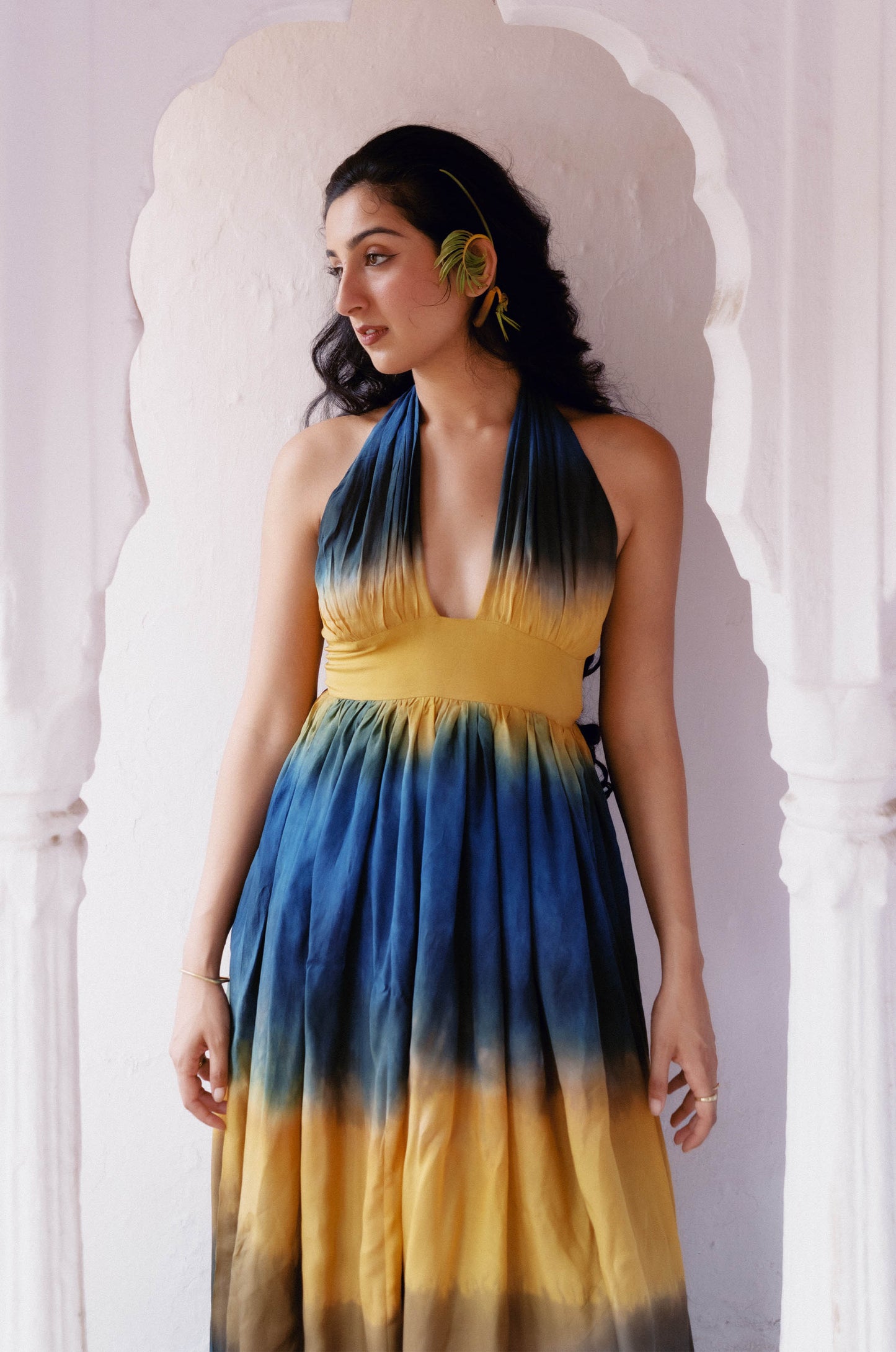 
                  
                    ZAZI Holiya hand-dyed maxi dress with halter neckline, flowing silhouette, and sunset-inspired watercolor hues, handcrafted in India by Heenaagrima artisans.
                  
                