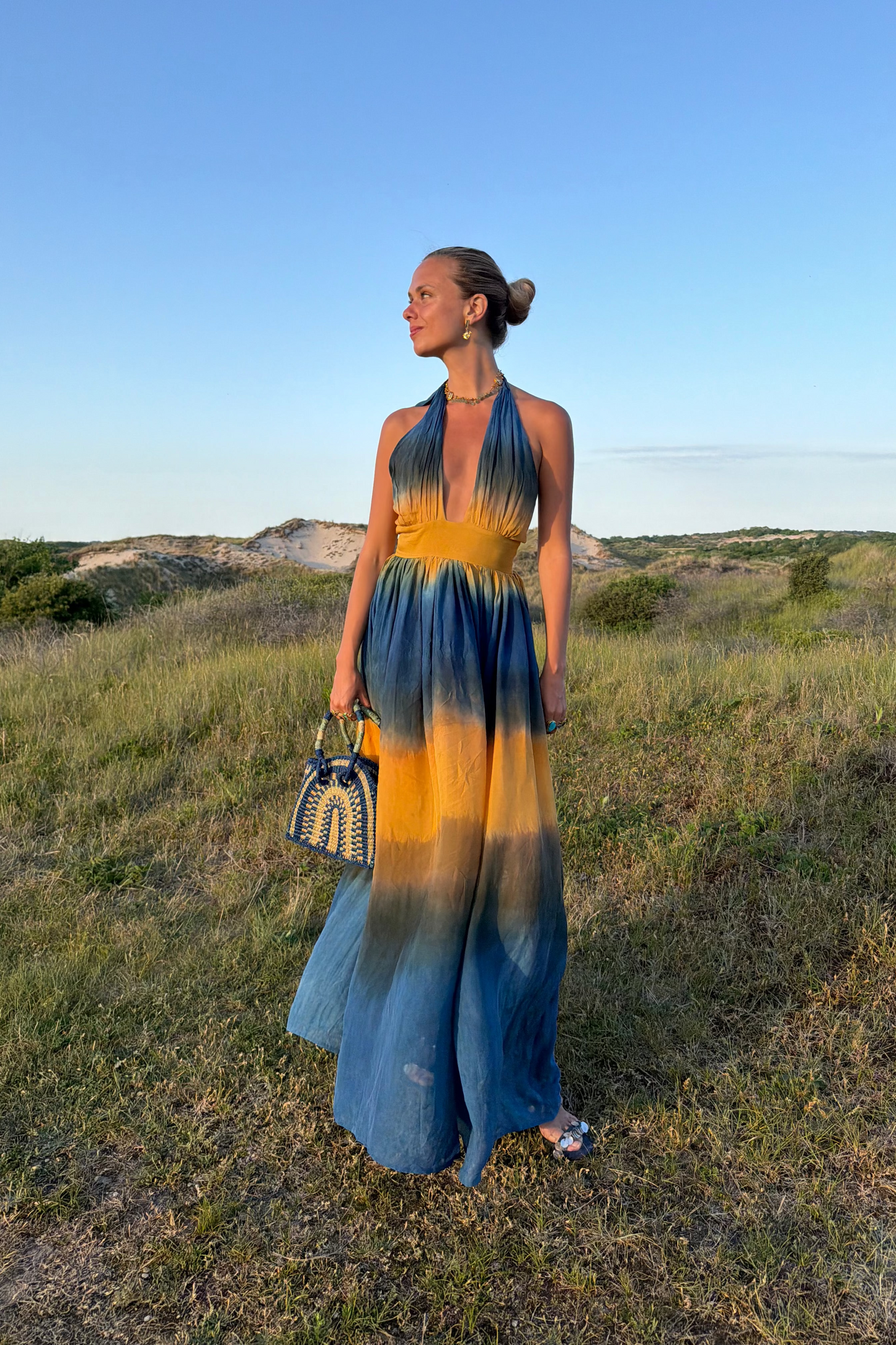 ZAZI Holiya hand-dyed maxi dress with halter neckline, flowing silhouette, and sunset-inspired watercolor hues, handcrafted in India by Heenaagrima artisans.