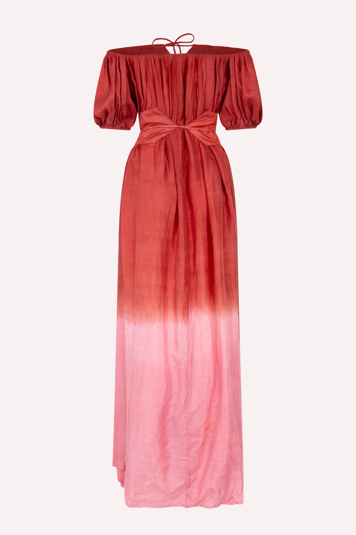 An off-shoulder, maxi dress with a gradient of red to pink color, featuring a waist accentuating belt.