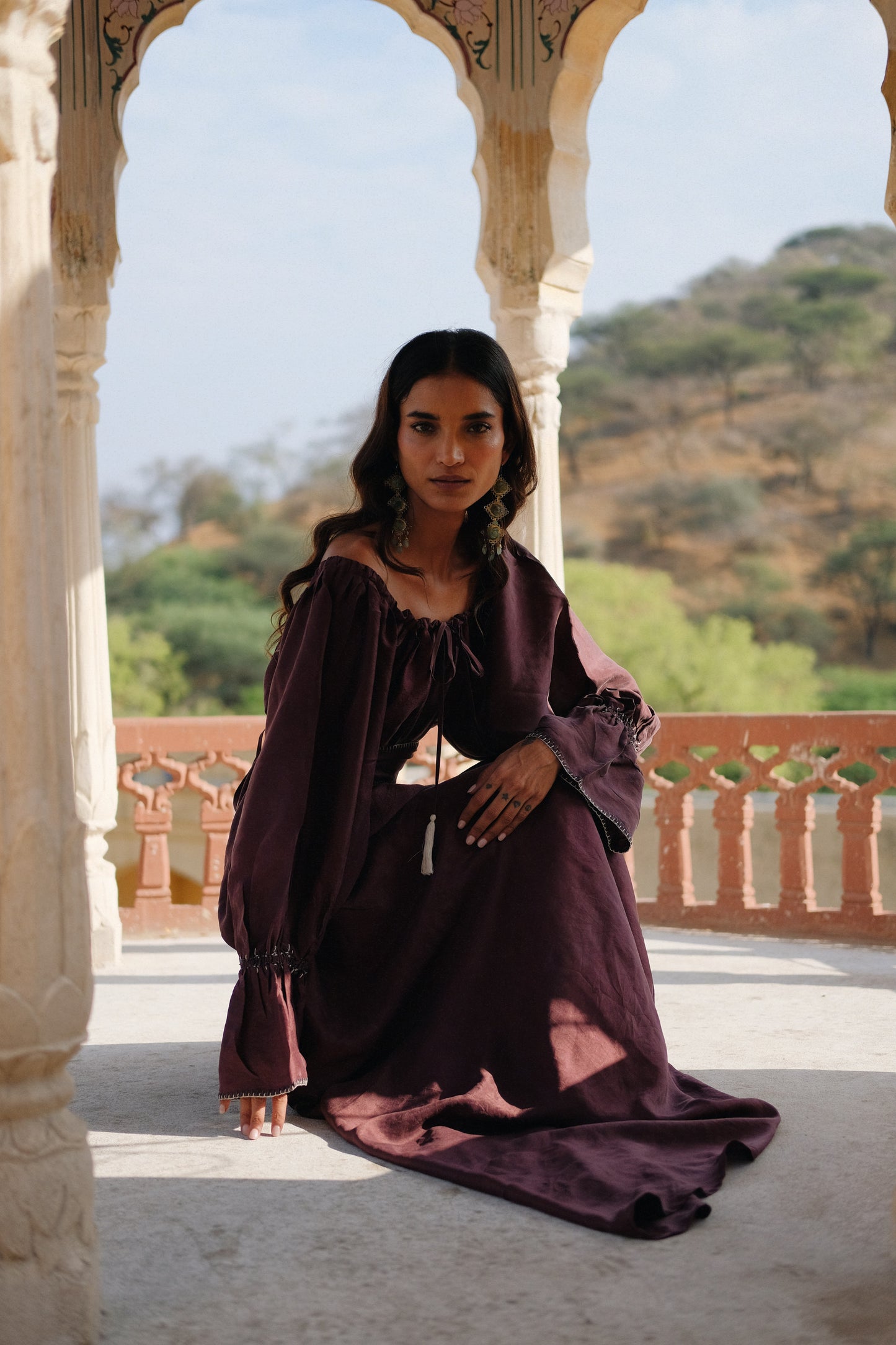 
                  
                    ZAZI Vayana Dress in handwoven Mulberry silk featuring a bohemian maxi silhouette, hand-embroidered details, versatile off-shoulder neckline, long sleeves, and matching belt.
                  
                