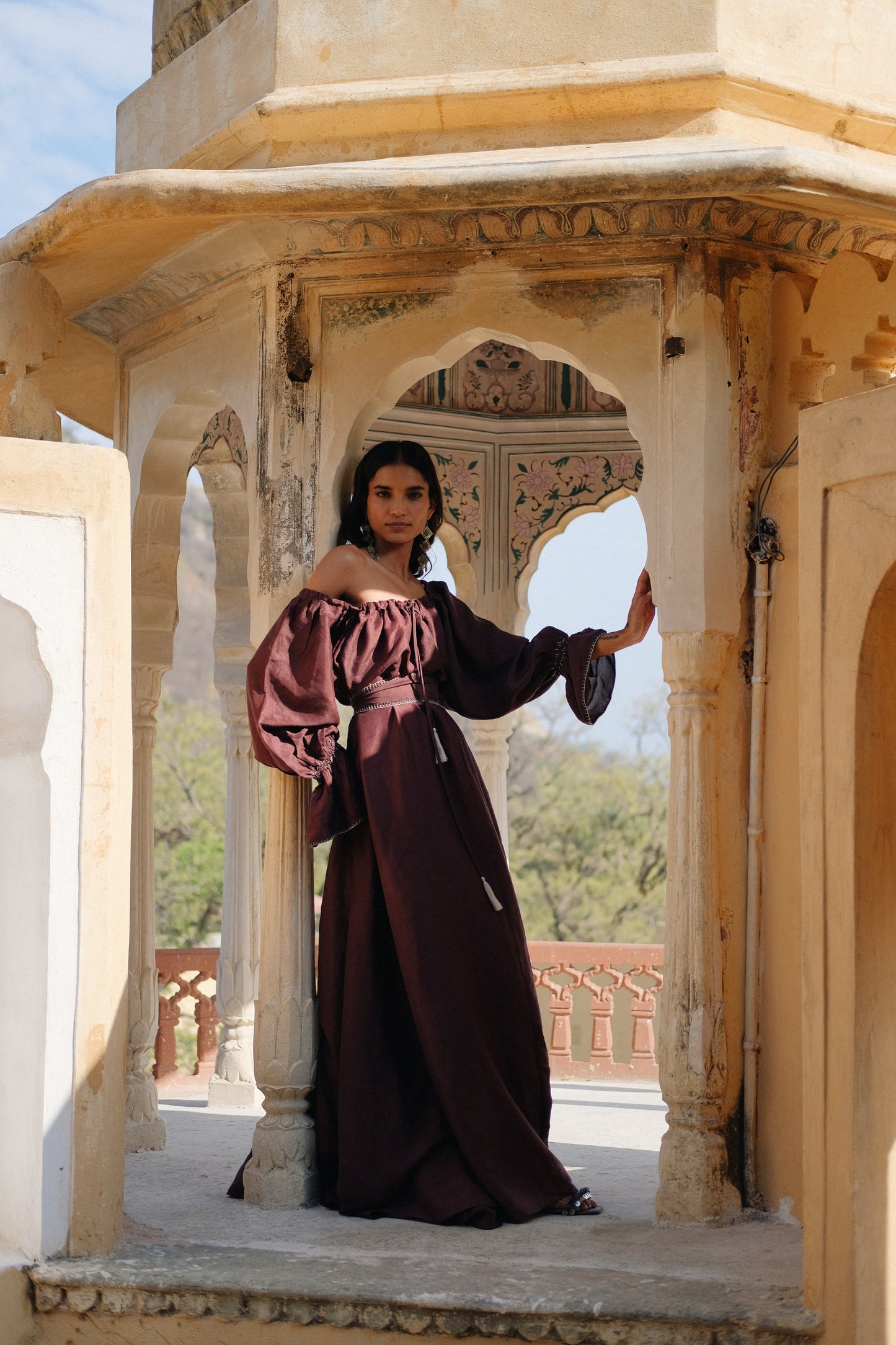 ZAZI Vayana Dress in handwoven Mulberry silk featuring a bohemian maxi silhouette, hand-embroidered details, versatile off-shoulder neckline, long sleeves, and matching belt.