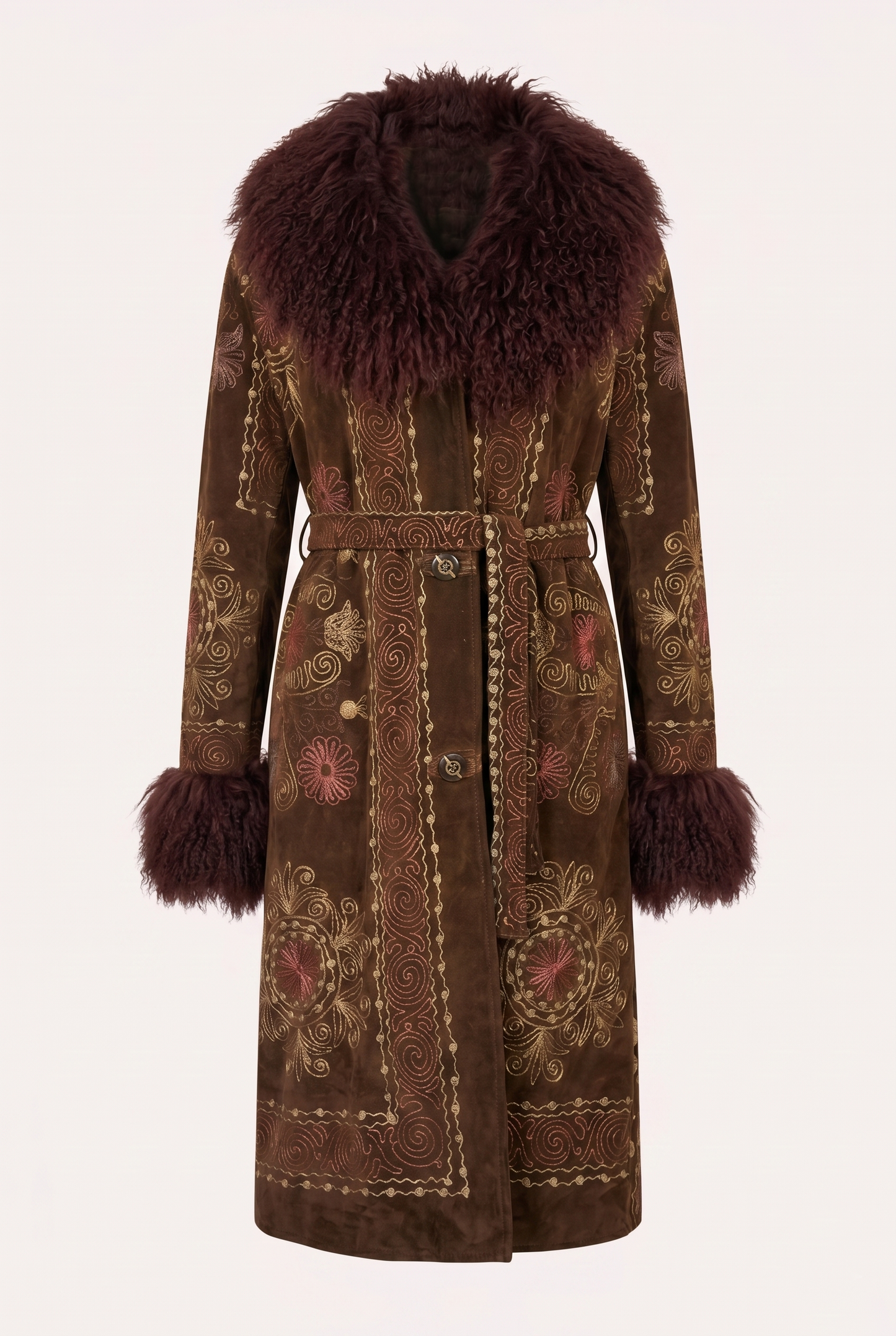 One-of-a-kind ZAZI Afghan coat crafted from vintage velours cotton suzani embroidery with an up-cycled sheepskin lining, featuring a belted 1970s Penny Lane silhouette and handcrafted by women artisans in Afghanistan.