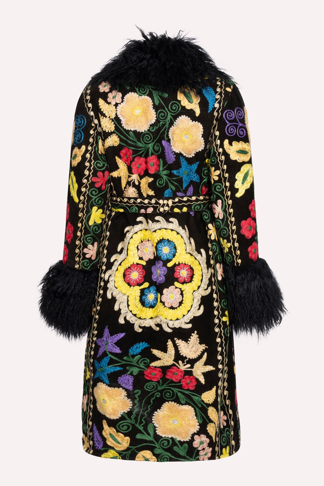 
                  
                    One-of-a-kind ZAZI Afghan coat crafted from vintage velours cotton suzani embroidery with an up-cycled sheepskin lining, featuring a belted 1970s Penny Lane silhouette and handcrafted by women artisans in Afghanistan.
                  
                