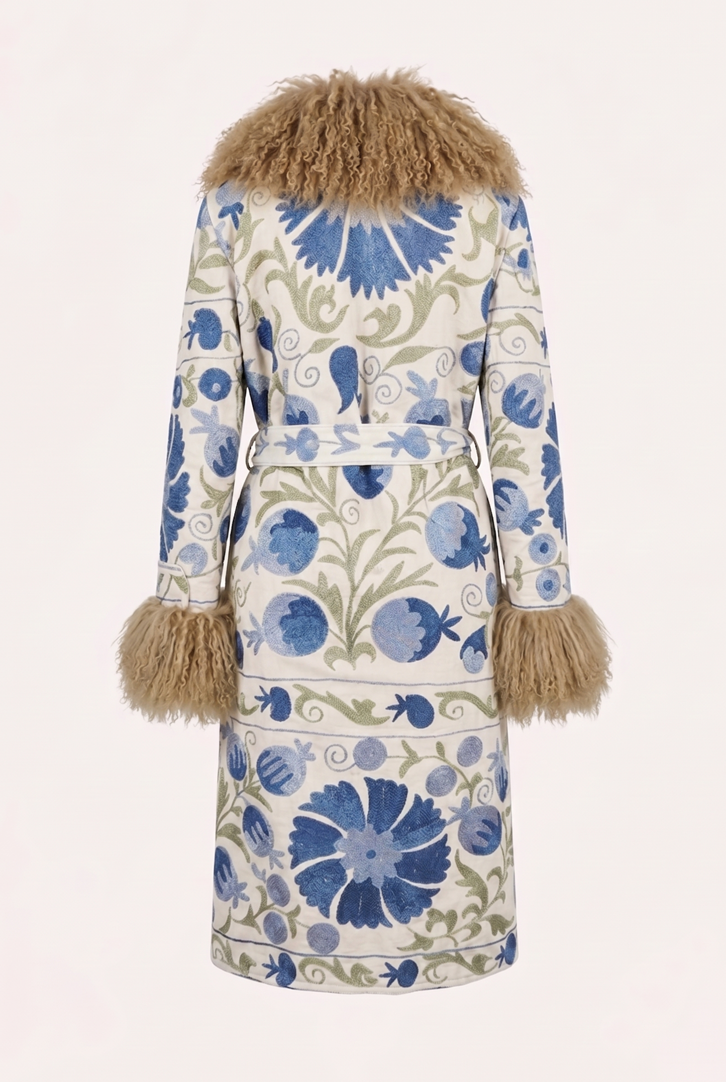 One-of-a-kind ZAZI Afghan coat crafted from vintage velours cotton suzani embroidery with an up-cycled sheepskin lining, featuring a belted 1970s Penny Lane silhouette and handcrafted by women artisans in Afghanistan.