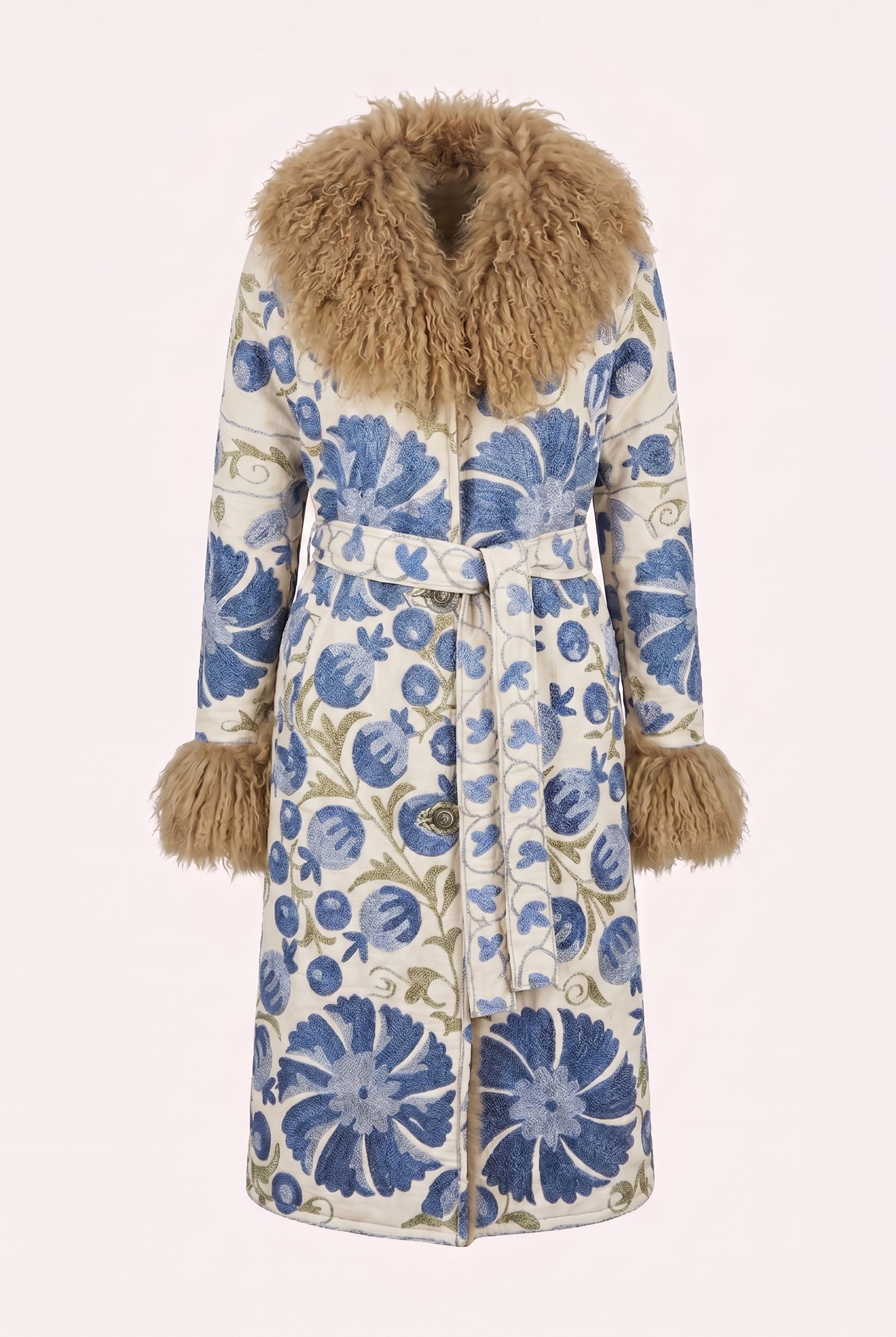 One-of-a-kind ZAZI Afghan coat crafted from vintage velours cotton suzani embroidery with an up-cycled sheepskin lining, featuring a belted 1970s Penny Lane silhouette and handcrafted by women artisans in Afghanistan.