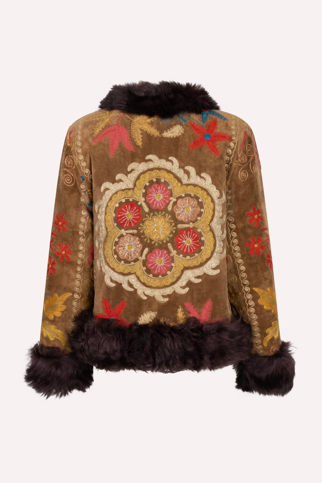 One-of-a-kind ZAZI Afghan coat crafted from vintage velours cotton suzani embroidery with an up-cycled sheepskin lining, featuring a belted 1970s Penny Lane silhouette and handcrafted by women artisans in Afghanistan.