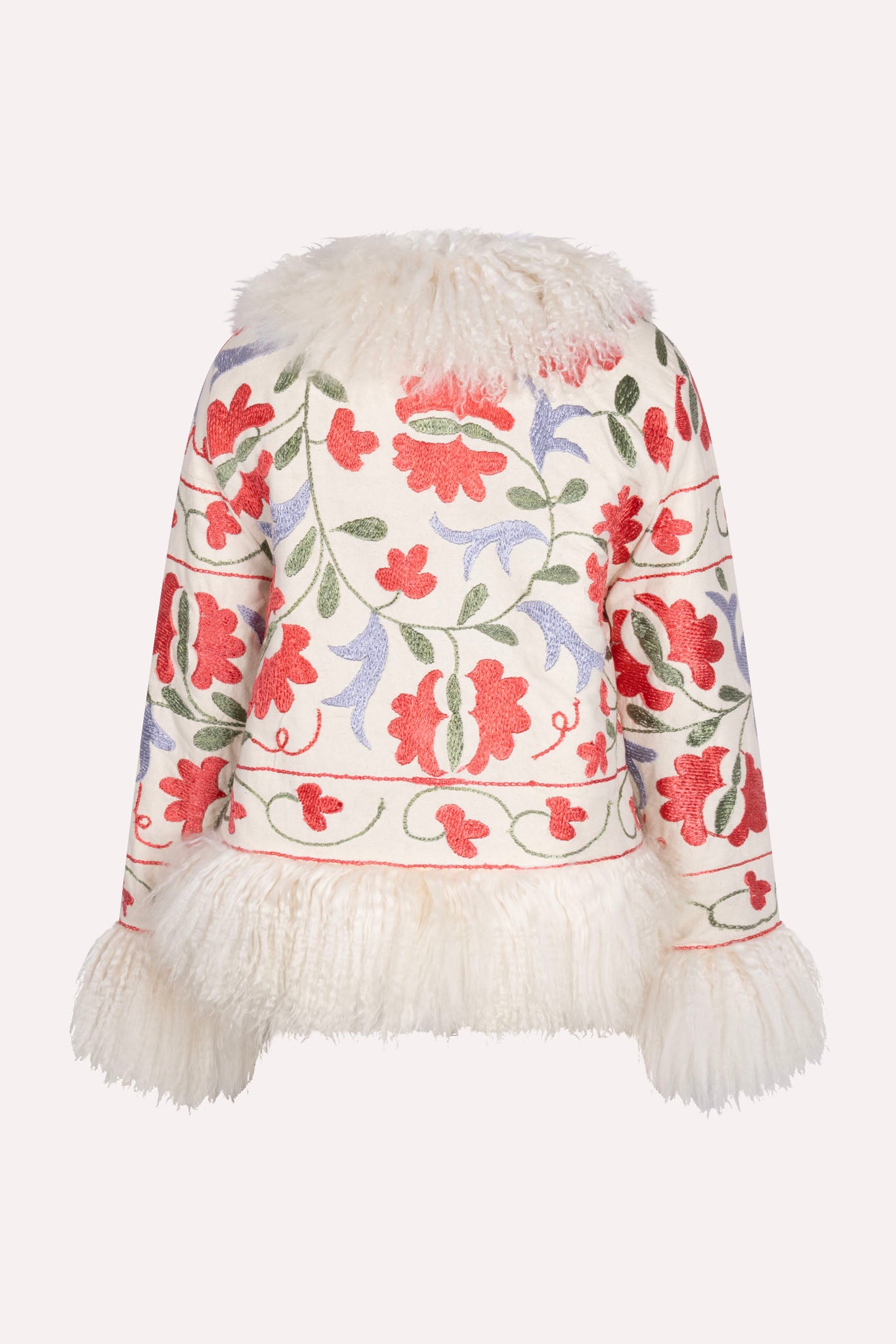 One-of-a-kind ZAZI Afghan coat crafted from vintage velours cotton suzani embroidery with an up-cycled sheepskin lining, featuring a belted 1970s Penny Lane silhouette and handcrafted by women artisans in Afghanistan.
