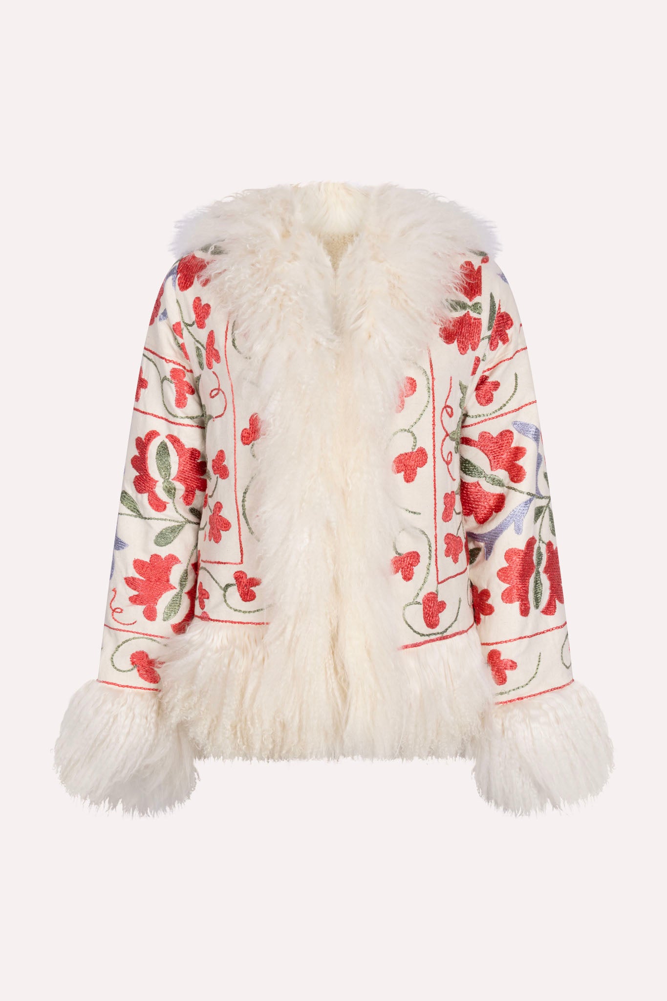 One-of-a-kind ZAZI Afghan coat crafted from vintage velours cotton suzani embroidery with an up-cycled sheepskin lining, featuring a belted 1970s Penny Lane silhouette and handcrafted by women artisans in Afghanistan.