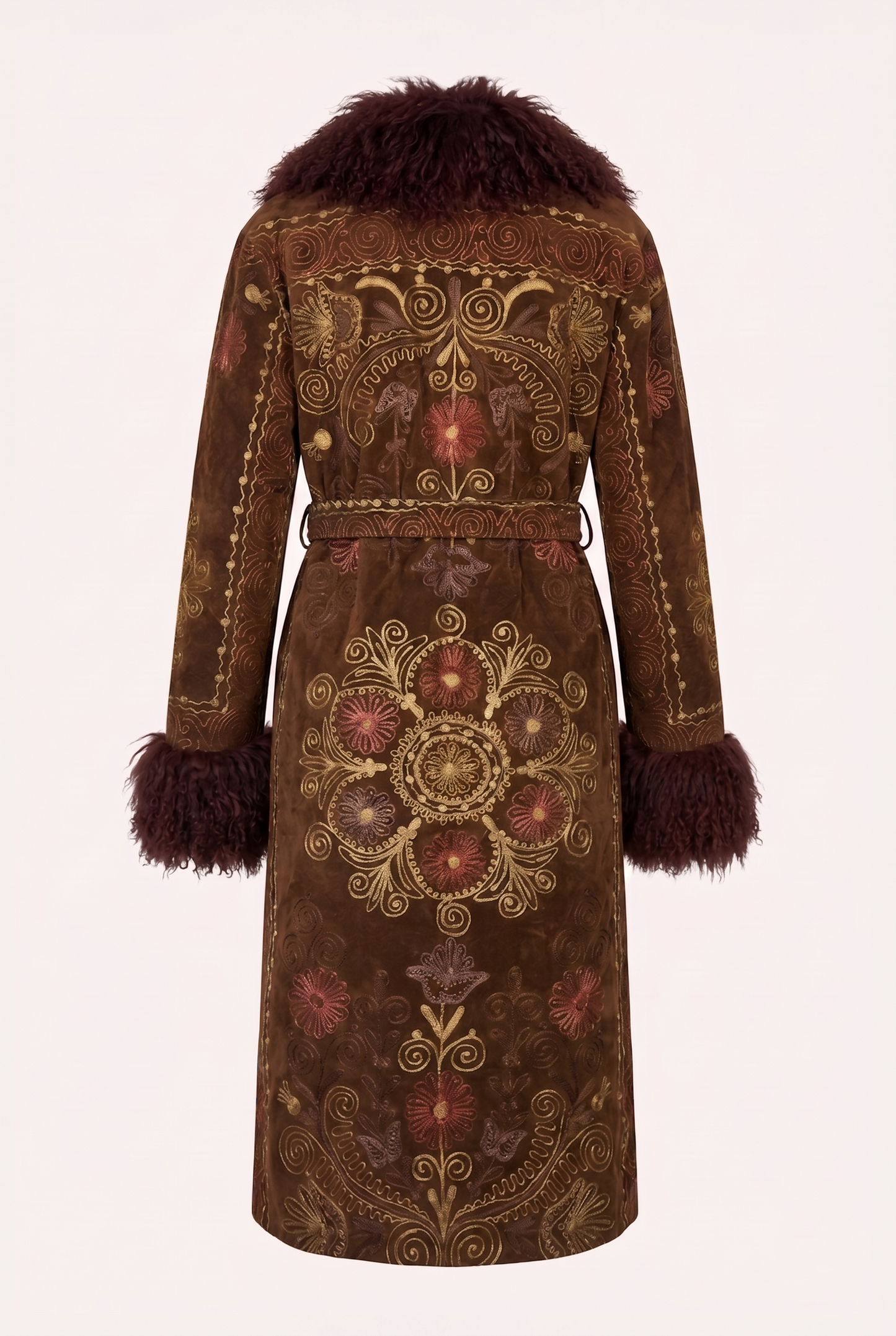 One-of-a-kind ZAZI Afghan coat crafted from vintage velours cotton suzani embroidery with an up-cycled sheepskin lining, featuring a belted 1970s Penny Lane silhouette and handcrafted by women artisans in Afghanistan.