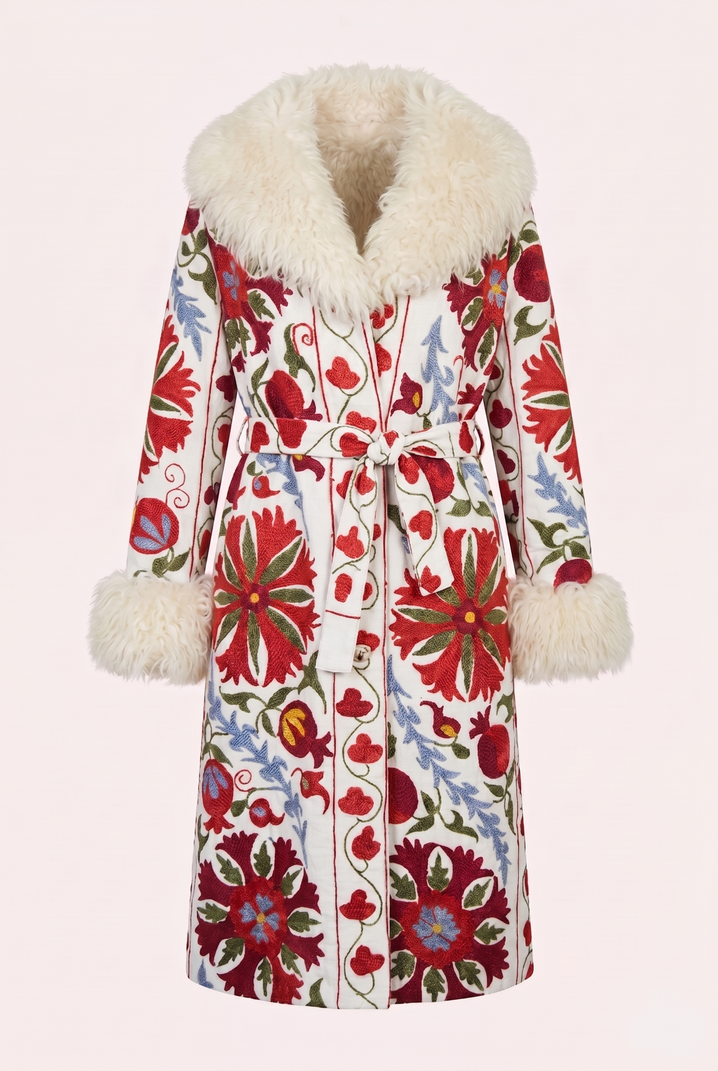 One-of-a-kind ZAZI Afghan coat crafted from vintage velours cotton suzani embroidery with an up-cycled sheepskin lining, featuring a belted 1970s Penny Lane silhouette and handcrafted by women artisans in Afghanistan.