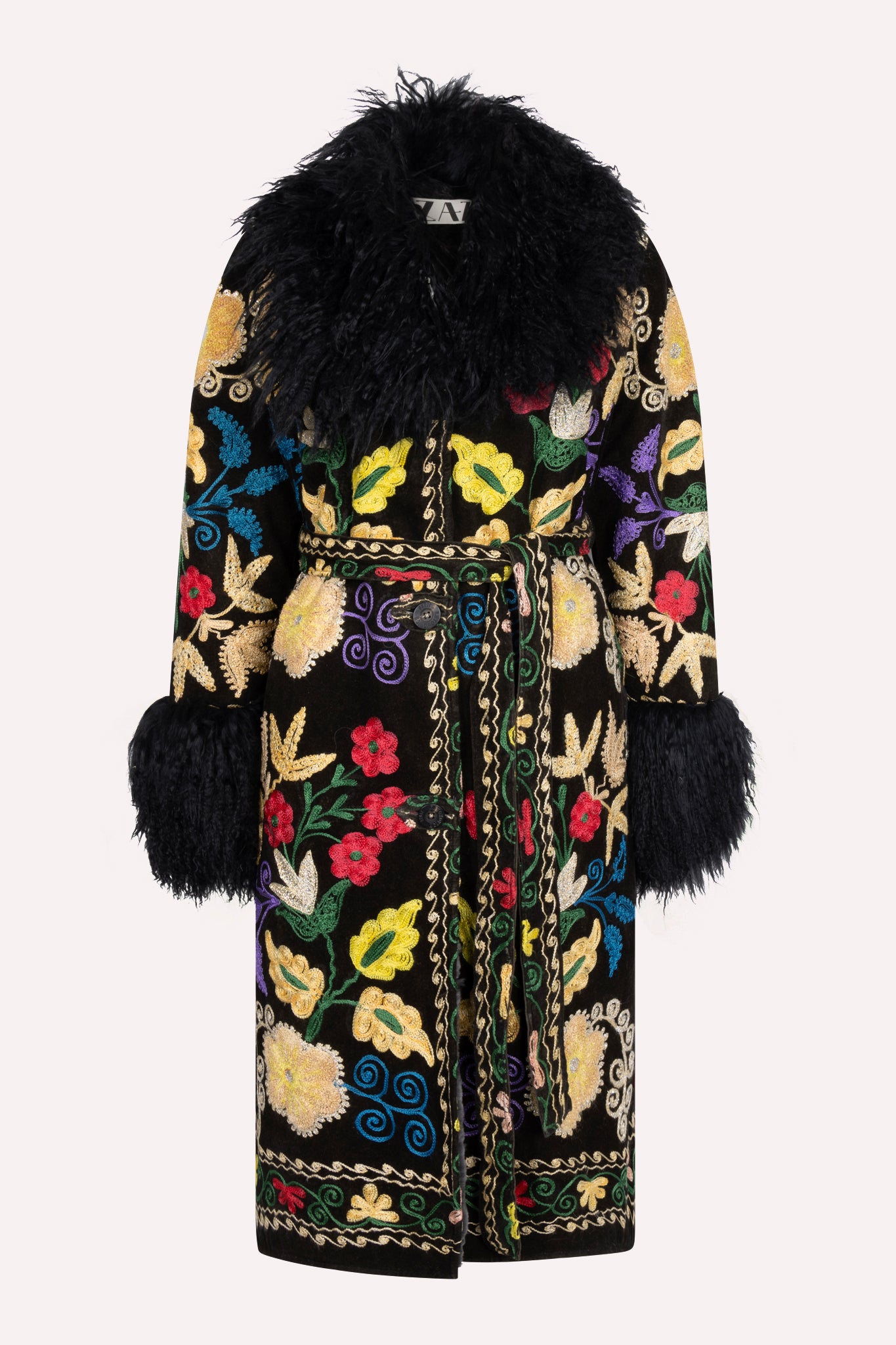 One-of-a-kind ZAZI Afghan coat crafted from vintage velours cotton suzani embroidery with an up-cycled sheepskin lining, featuring a belted 1970s Penny Lane silhouette and handcrafted by women artisans in Afghanistan.
