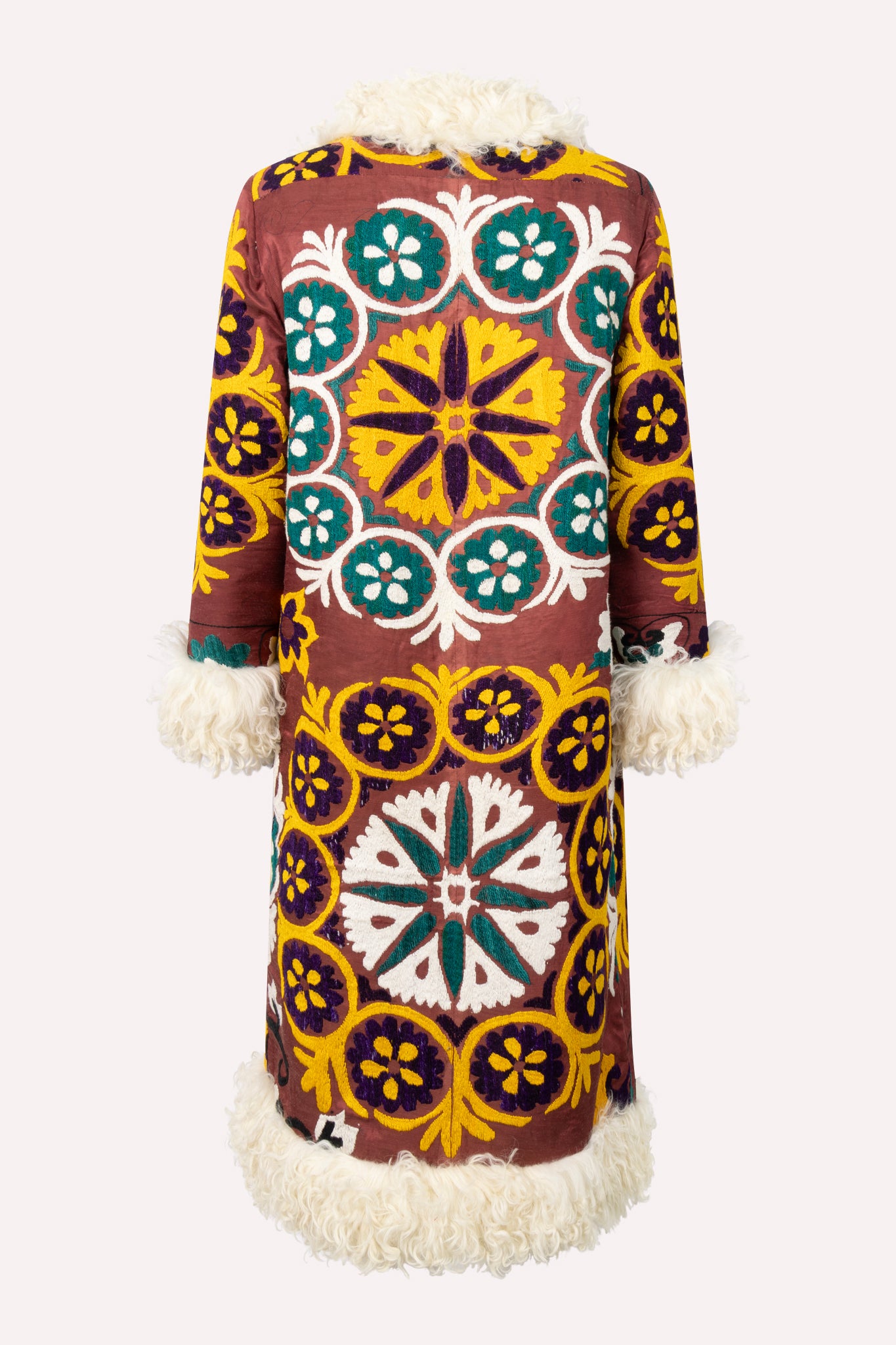 Handcrafted ZAZI Afghan straight coat made from hand-embroidered vintage cotton suzani, featuring a 70s Penny Lane–inspired silhouette, hook closure, colorful floral patterns, and up-cycled sheepskin lining.