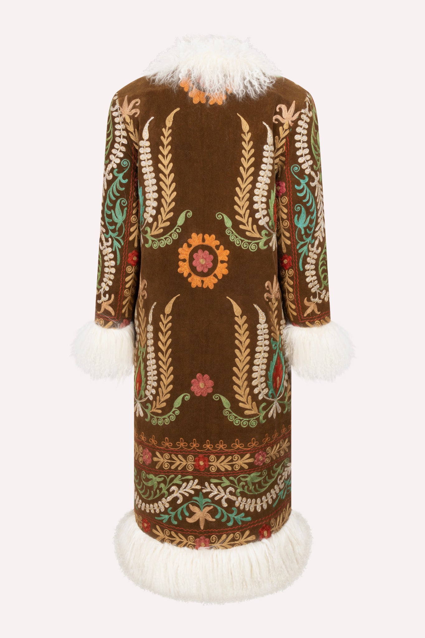 Handcrafted ZAZI Afghan straight coat made from vintage cotton suzani embroidery, featuring a 70s Penny Lane–inspired silhouette, hook closure, colorful floral patterns, and up-cycled sheepskin lining.