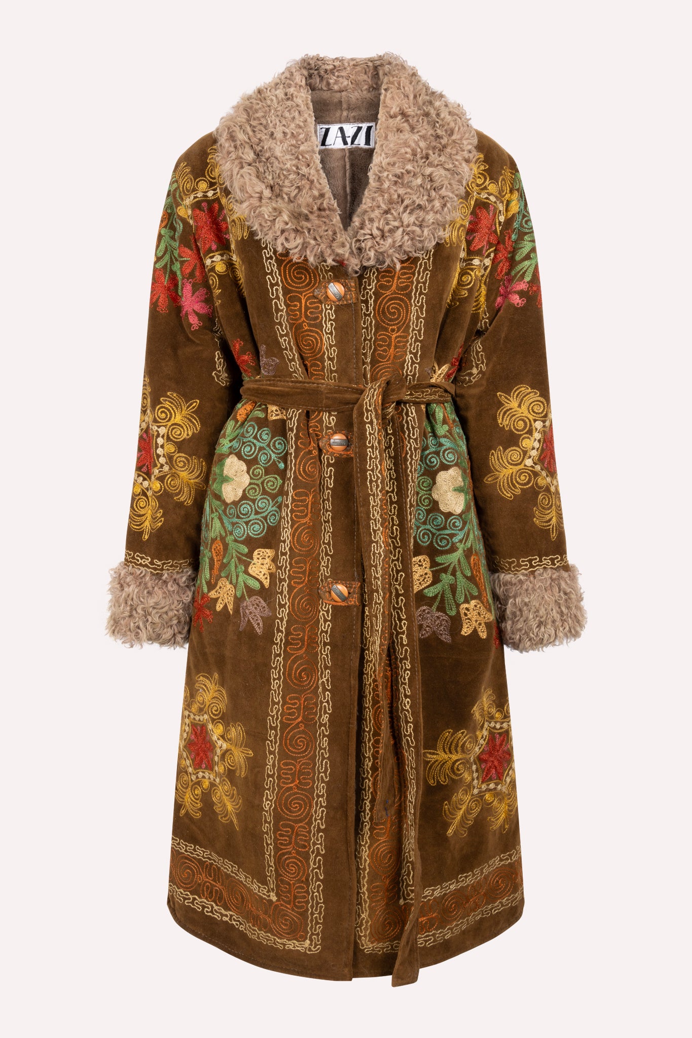 Handcrafted ZAZI Afghan coat made from vintage velours cotton suzani embroidery with upcycled sheepskin lining, featuring a waist-accentuating belt, vintage front buttons, and a 1970s-inspired silhouette, created by women artisans in Afghanistan.
