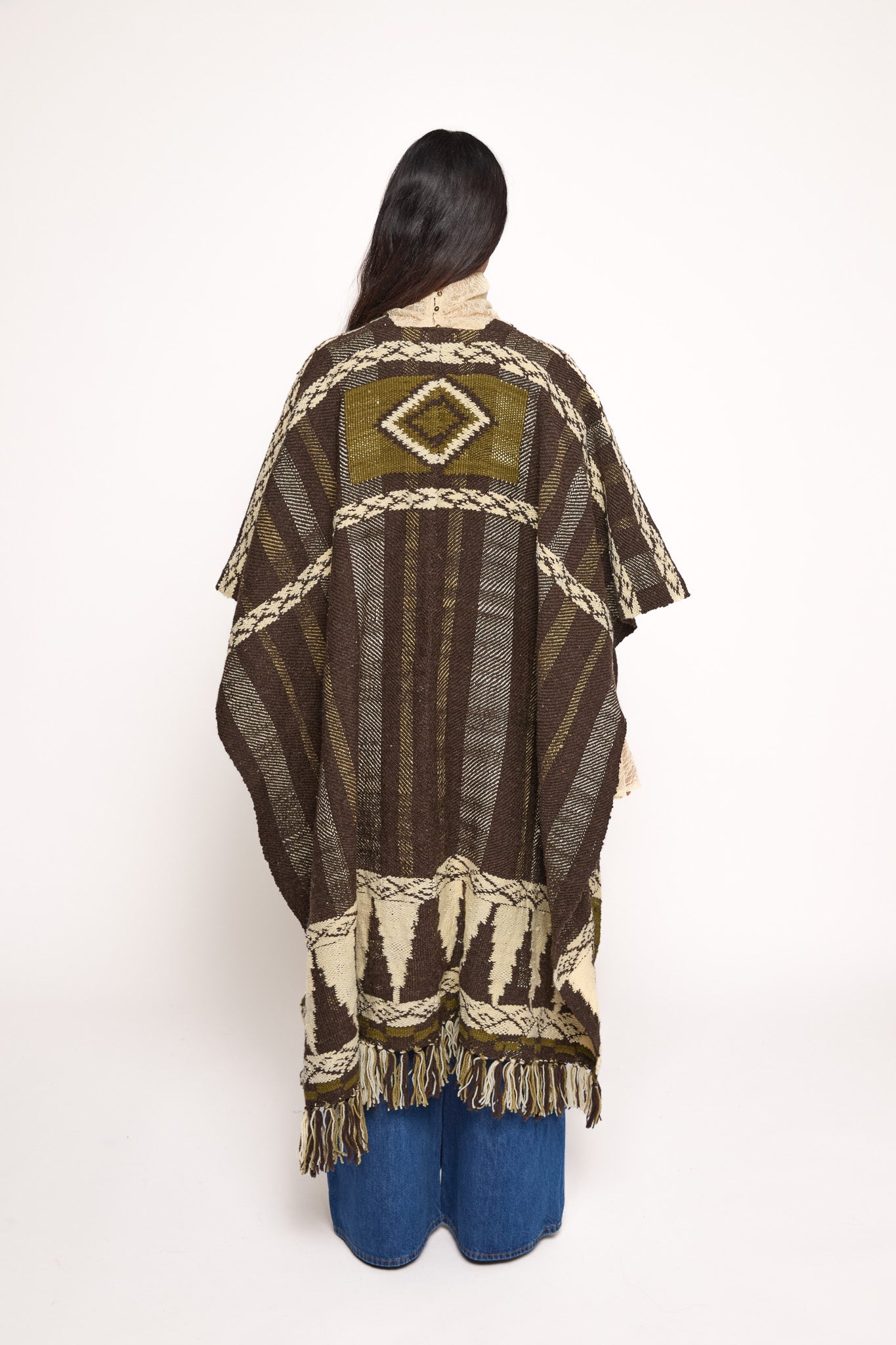 
                  
                    Handmade ZAZI wool cape inspired by Himalayan artisans, featuring intricate weaving, natural dyes, and tassels, modeled by a 174 cm tall woman.
                  
                