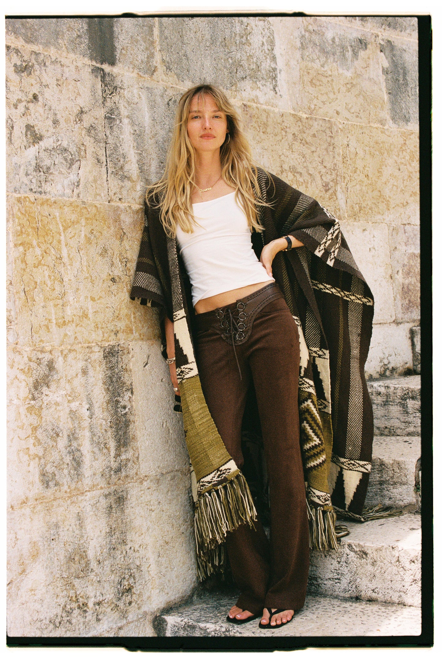 
                  
                    Handmade ZAZI wool cape inspired by Himalayan artisans, featuring intricate weaving, natural dyes, and tassels, modeled by a 174 cm tall woman.
                  
                