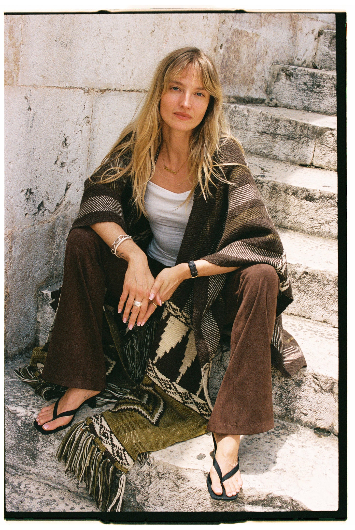 
                  
                    Handmade ZAZI wool cape inspired by Himalayan artisans, featuring intricate weaving, natural dyes, and tassels, modeled by a 174 cm tall woman.
                  
                