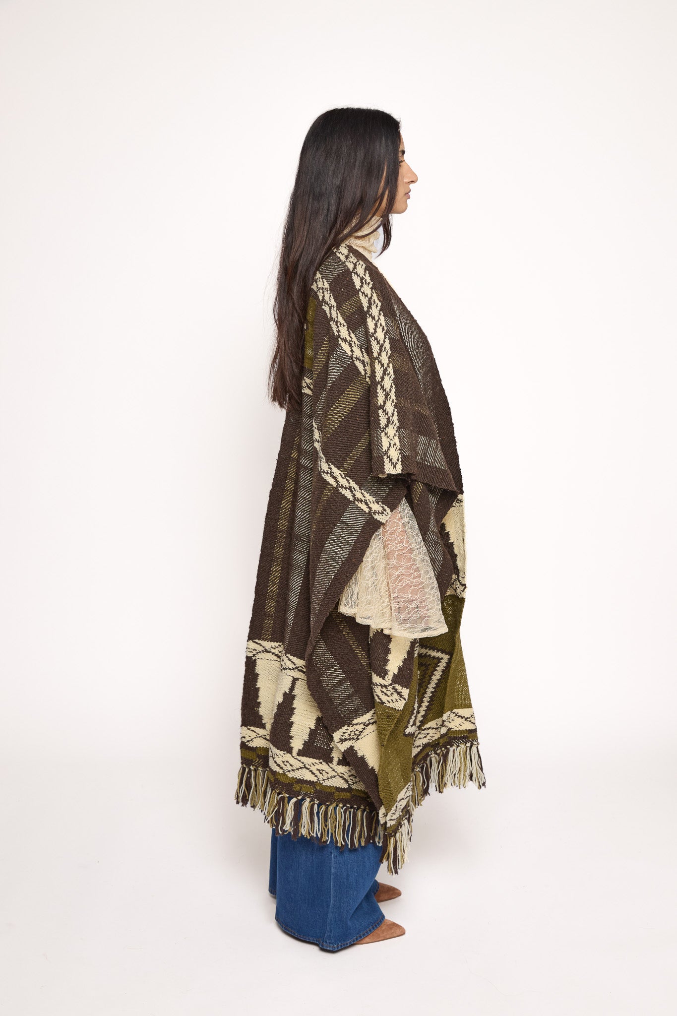 
                  
                    Handmade ZAZI wool cape inspired by Himalayan artisans, featuring intricate weaving, natural dyes, and tassels, modeled by a 174 cm tall woman.
                  
                