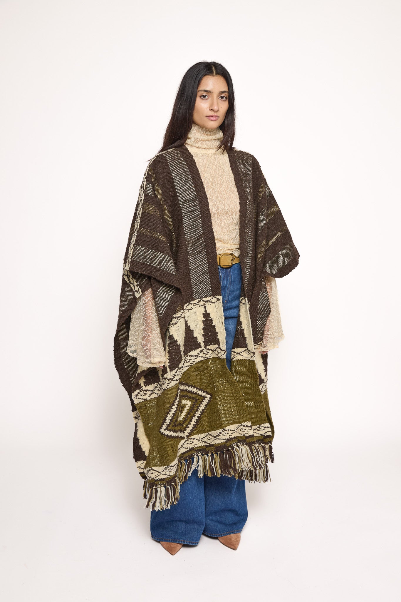 
                  
                    Handmade ZAZI wool cape inspired by Himalayan artisans, featuring intricate weaving, natural dyes, and tassels, modeled by a 174 cm tall woman.
                  
                