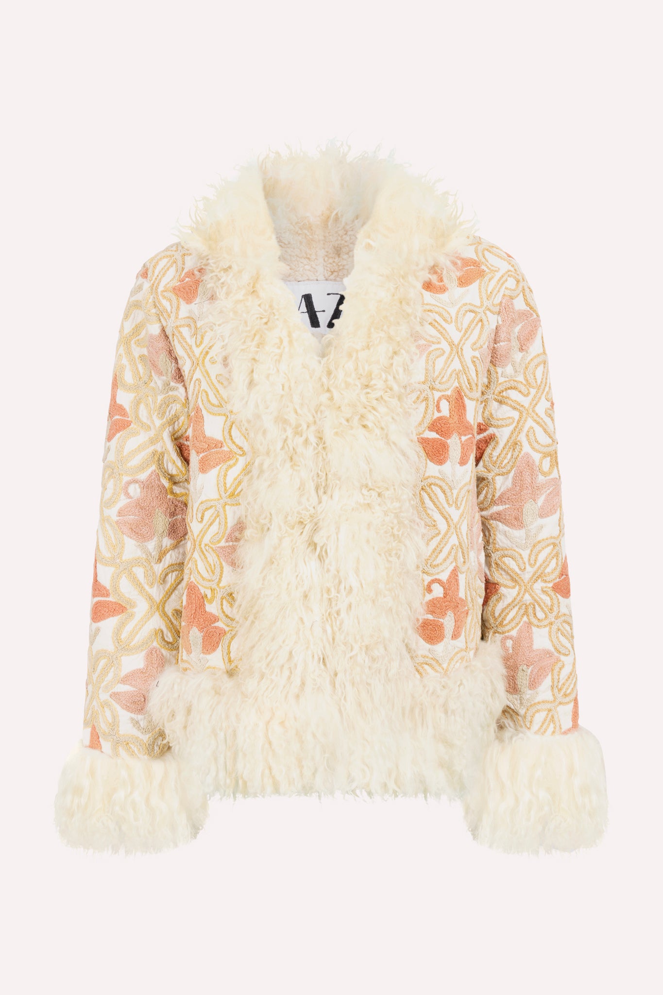 Short ZAZI Afghan coat handcrafted from hand-embroidered vintage cotton suzani with upcycled sheepskin lining, featuring a straight 1970s-inspired silhouette with hook closures, made by women artisans in Afghanistan.