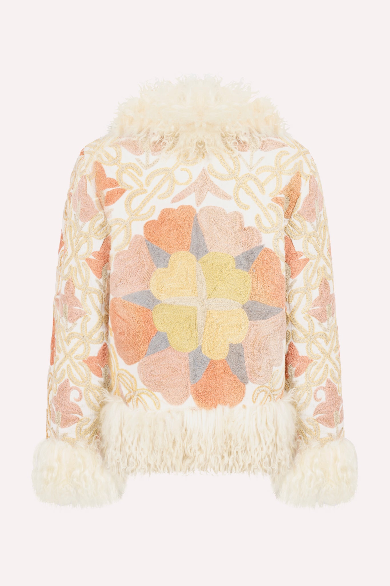 Short ZAZI Afghan coat handcrafted from hand-embroidered vintage cotton suzani with upcycled sheepskin lining, featuring a straight 1970s-inspired silhouette with hook closures, made by women artisans in Afghanistan.