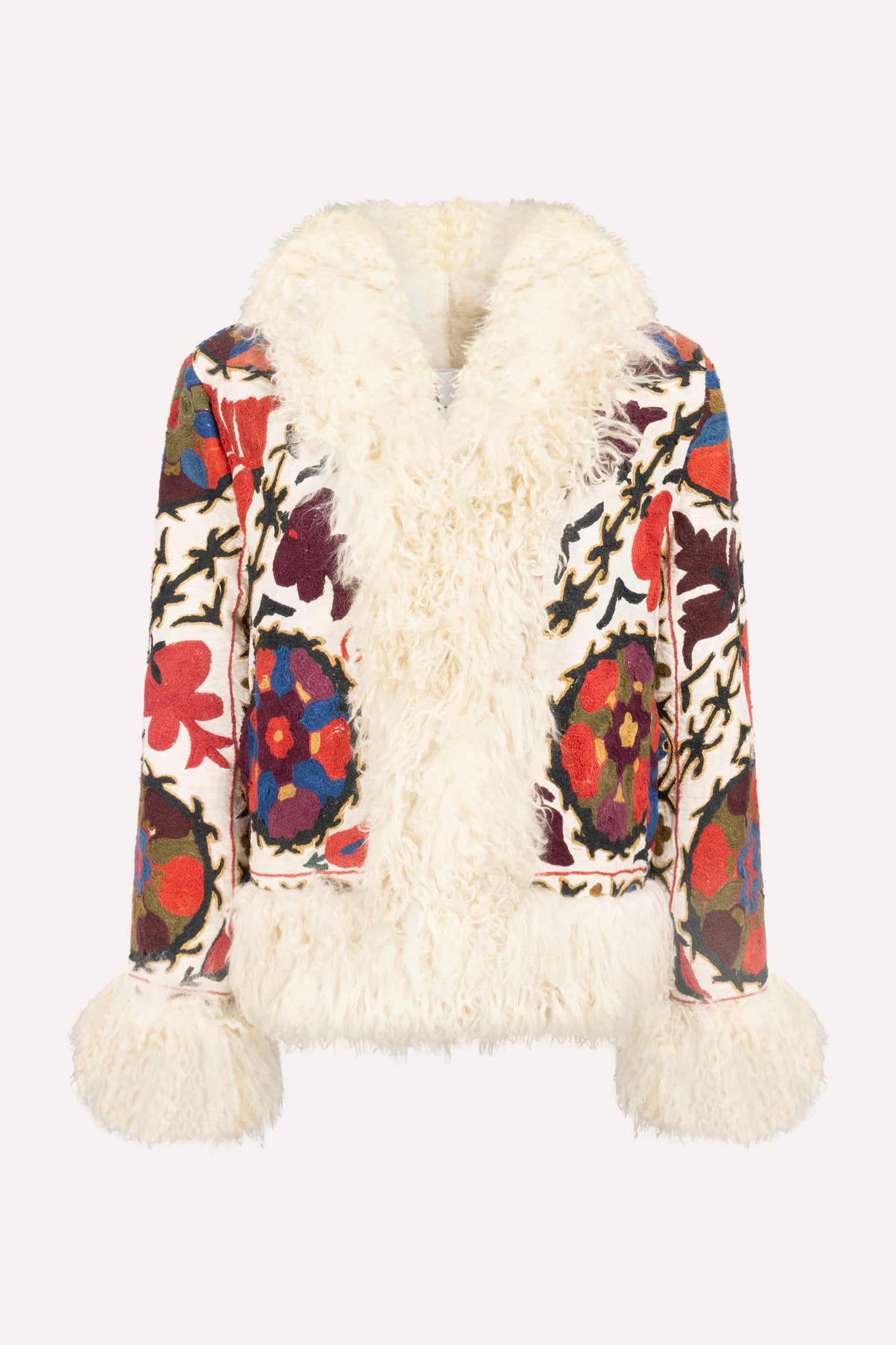 Short ZAZI Afghan coat handcrafted from vintage cotton suzani embroidery with upcycled sheepskin lining, featuring a straight 1970s-inspired silhouette with hook closures, made by women artisans in Afghanistan.