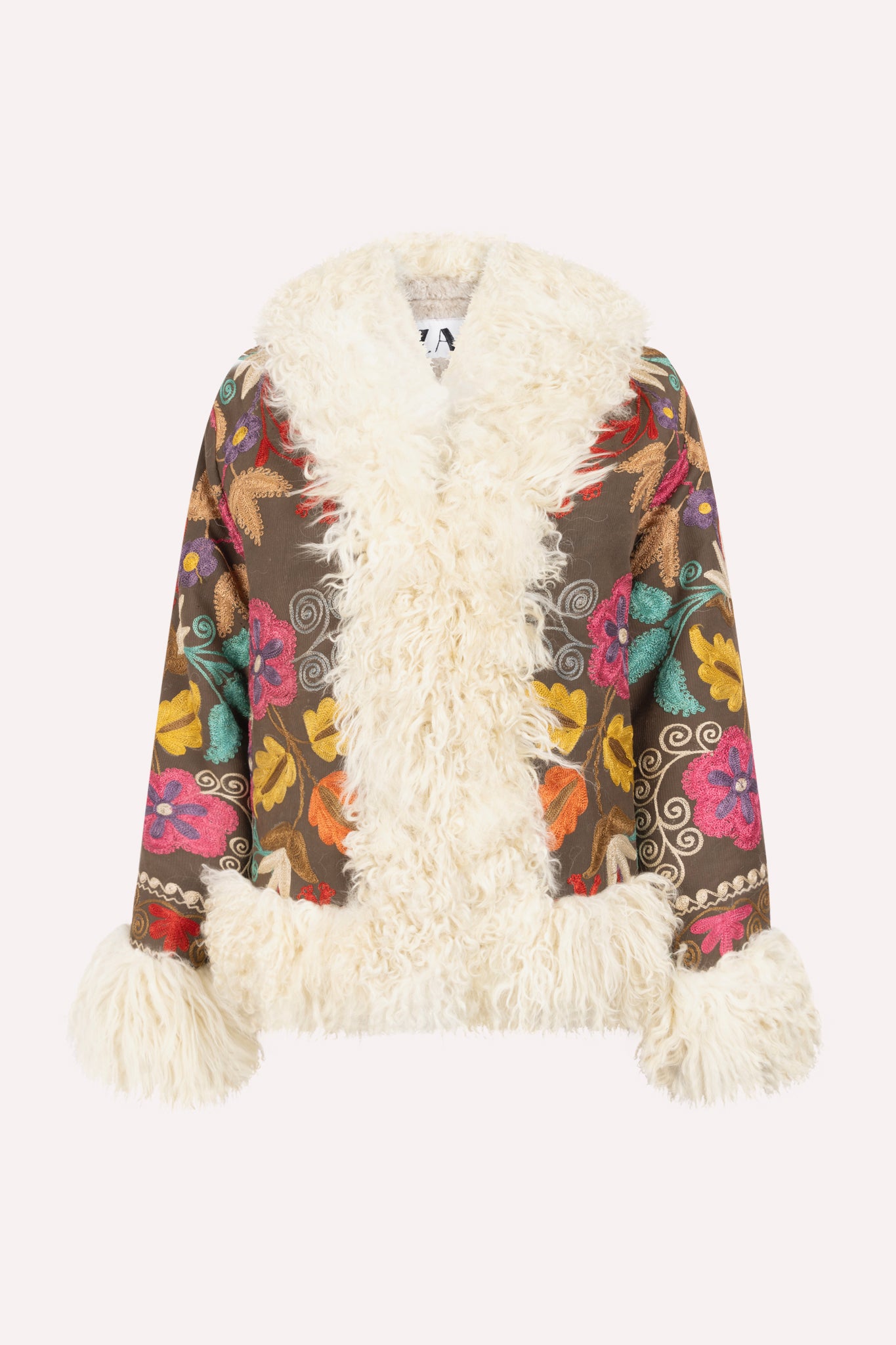 Short ZAZI Afghan coat handcrafted from vintage cotton suzani embroidery with upcycled sheepskin lining, featuring a straight 1970s-inspired silhouette with hook closures, made by women artisans in Afghanistan.