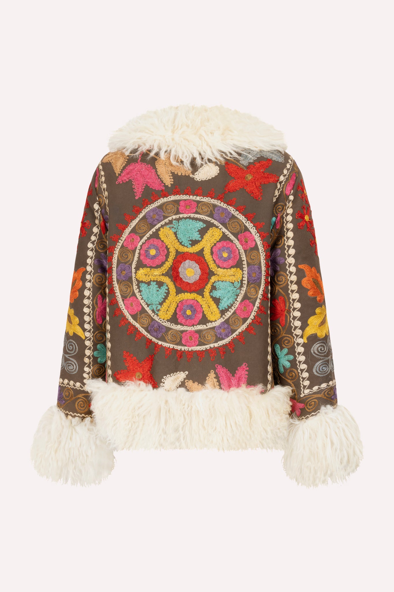 Short ZAZI Afghan coat handcrafted from vintage cotton suzani embroidery with upcycled sheepskin lining, featuring a straight 1970s-inspired silhouette with hook closures, made by women artisans in Afghanistan.