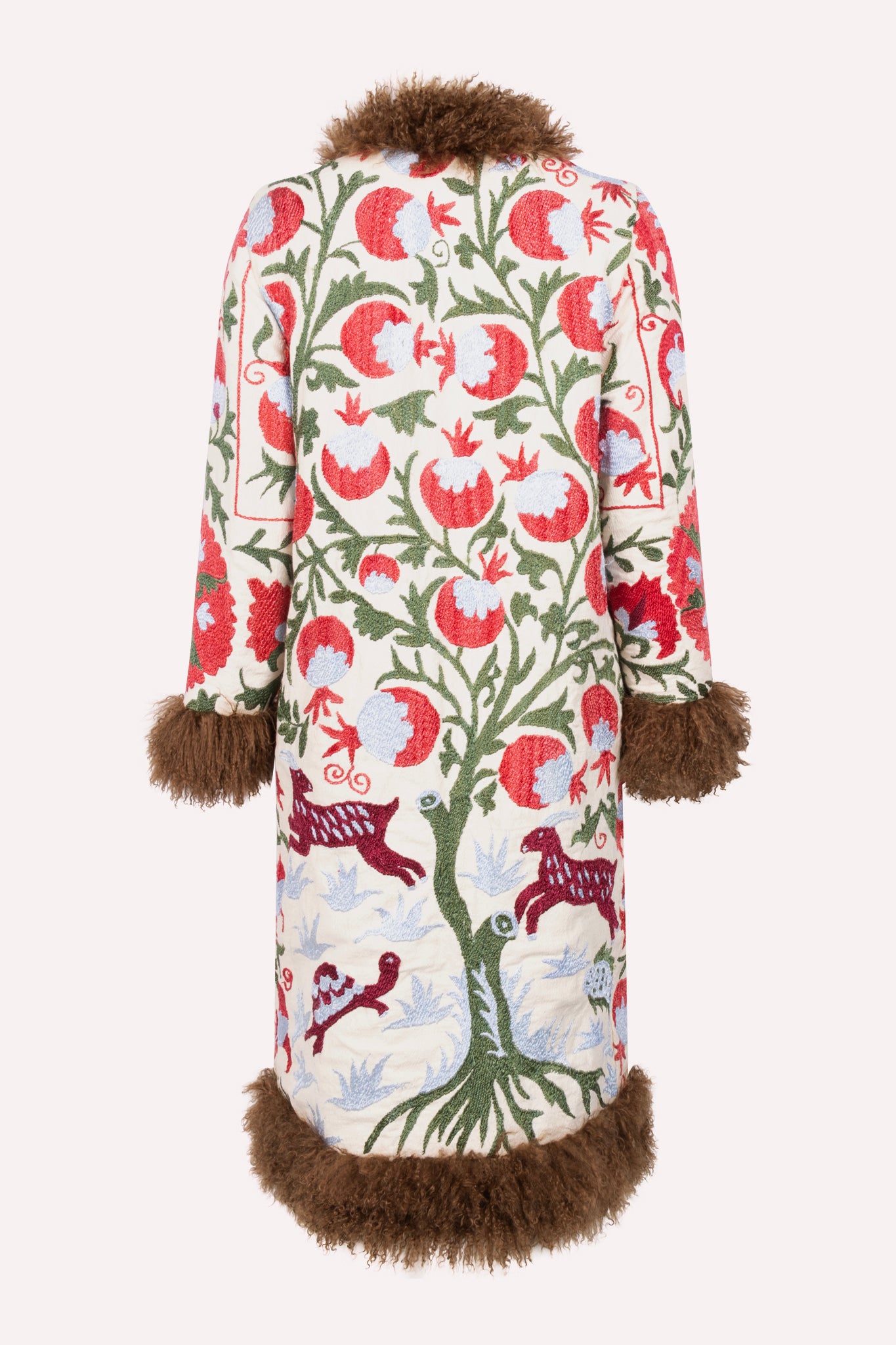 Handcrafted ZAZI Afghan coat made from vintage cotton suzani embroidery with upcycled sheepskin lining, featuring a straight 1970s-inspired silhouette with hook closures, created by women artisans in Afghanistan.