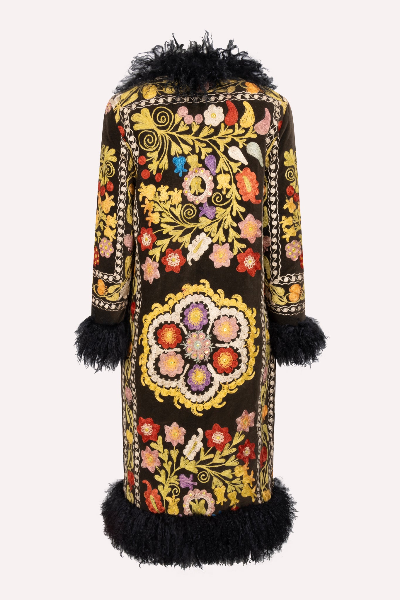 Handcrafted ZAZI Afghan coat made from vintage cotton suzani embroidery with upcycled sheepskin lining, featuring a straight 1970s-inspired silhouette with hook closures, created by women artisans in Afghanistan.