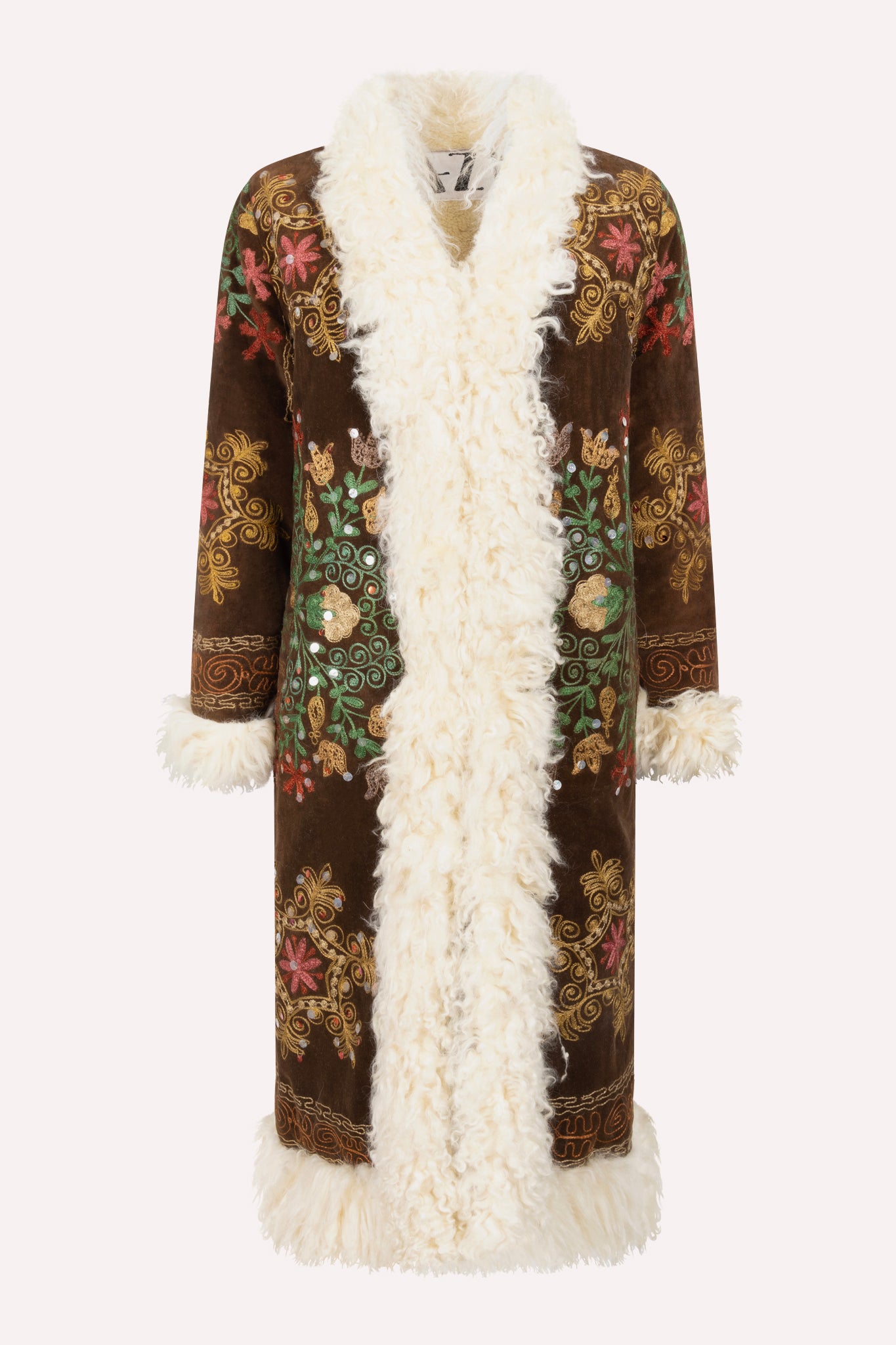 Handcrafted ZAZI Afghan coat made from vintage cotton suzani embroidery with upcycled sheepskin lining, featuring a straight 1970s-inspired silhouette with hook closures, created by women artisans in Afghanistan.
