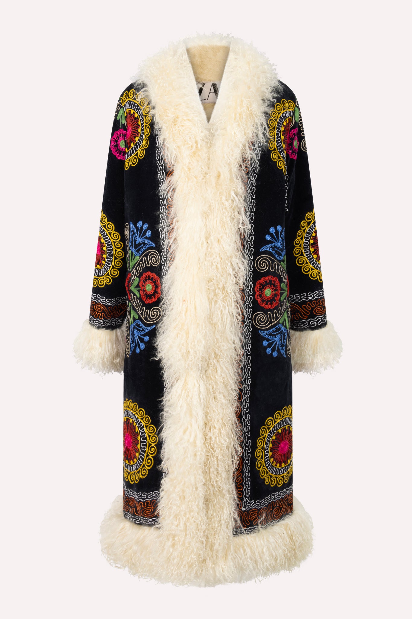 Handcrafted ZAZI Afghan coat made from vintage cotton suzani embroidery with upcycled sheepskin lining, featuring a straight 1970s-inspired silhouette with hook closures, created by women artisans in Afghanistan.