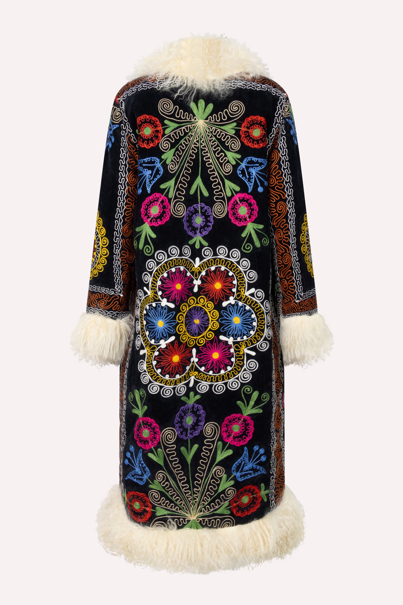 Handcrafted ZAZI Afghan coat made from vintage cotton suzani embroidery with upcycled sheepskin lining, featuring a straight 1970s-inspired silhouette with hook closures, created by women artisans in Afghanistan.