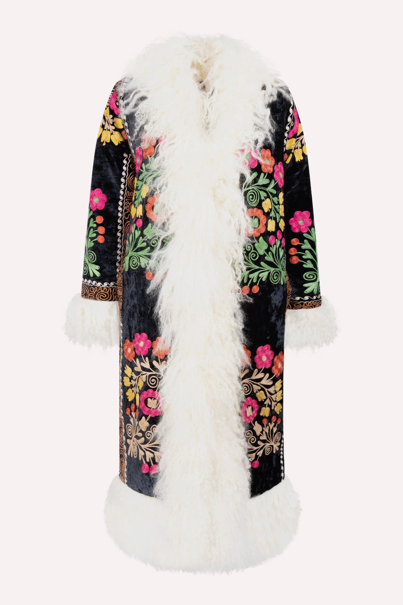 Handcrafted ZAZI Afghan coat made from vintage velours cotton suzani embroidery with upcycled sheepskin lining, featuring a straight 1970s-inspired silhouette with hook closures, created by women artisans in Afghanistan.