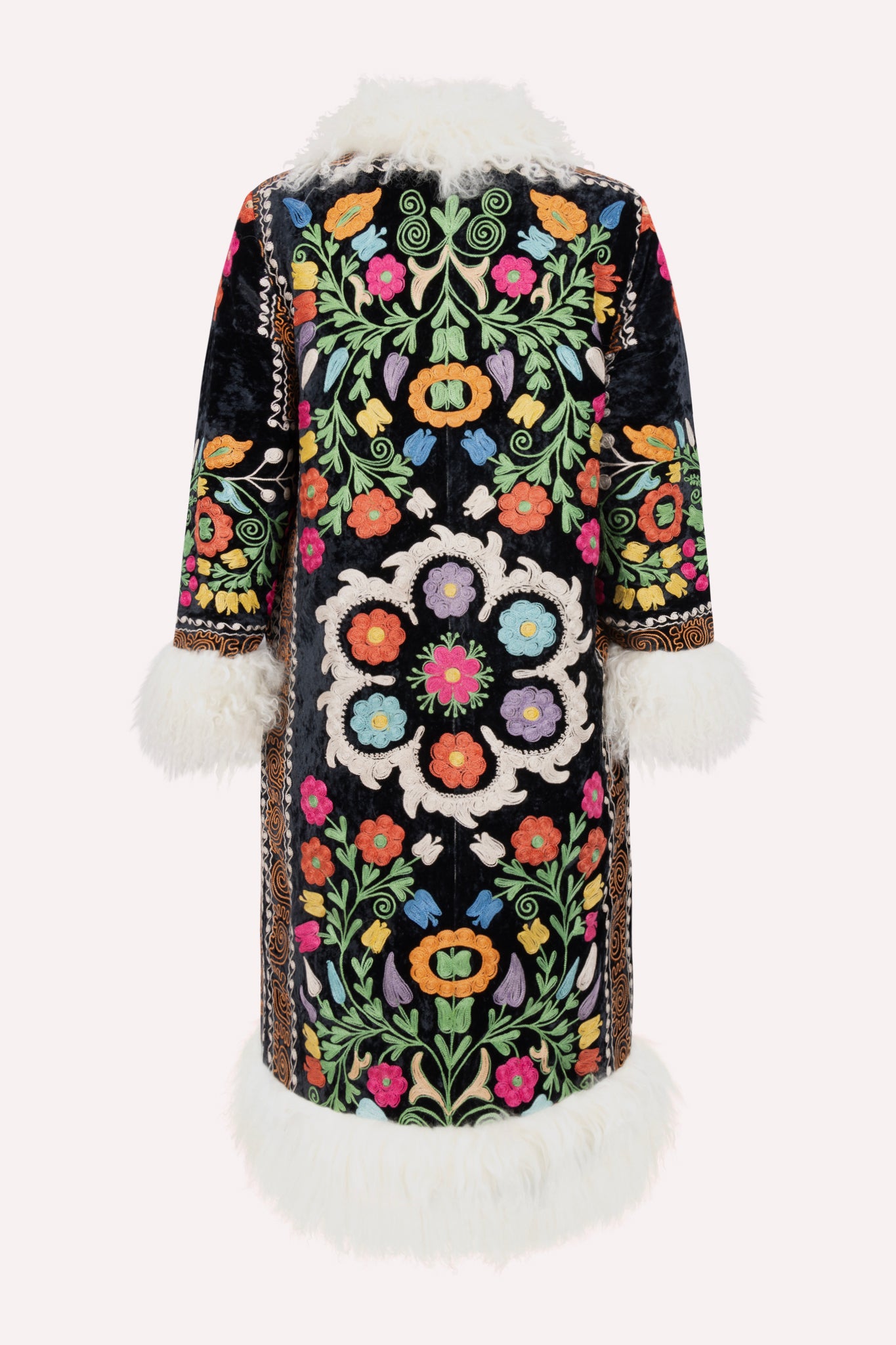 Handcrafted ZAZI Afghan coat made from vintage velours cotton suzani embroidery with upcycled sheepskin lining, featuring a straight 1970s-inspired silhouette with hook closures, created by women artisans in Afghanistan.
