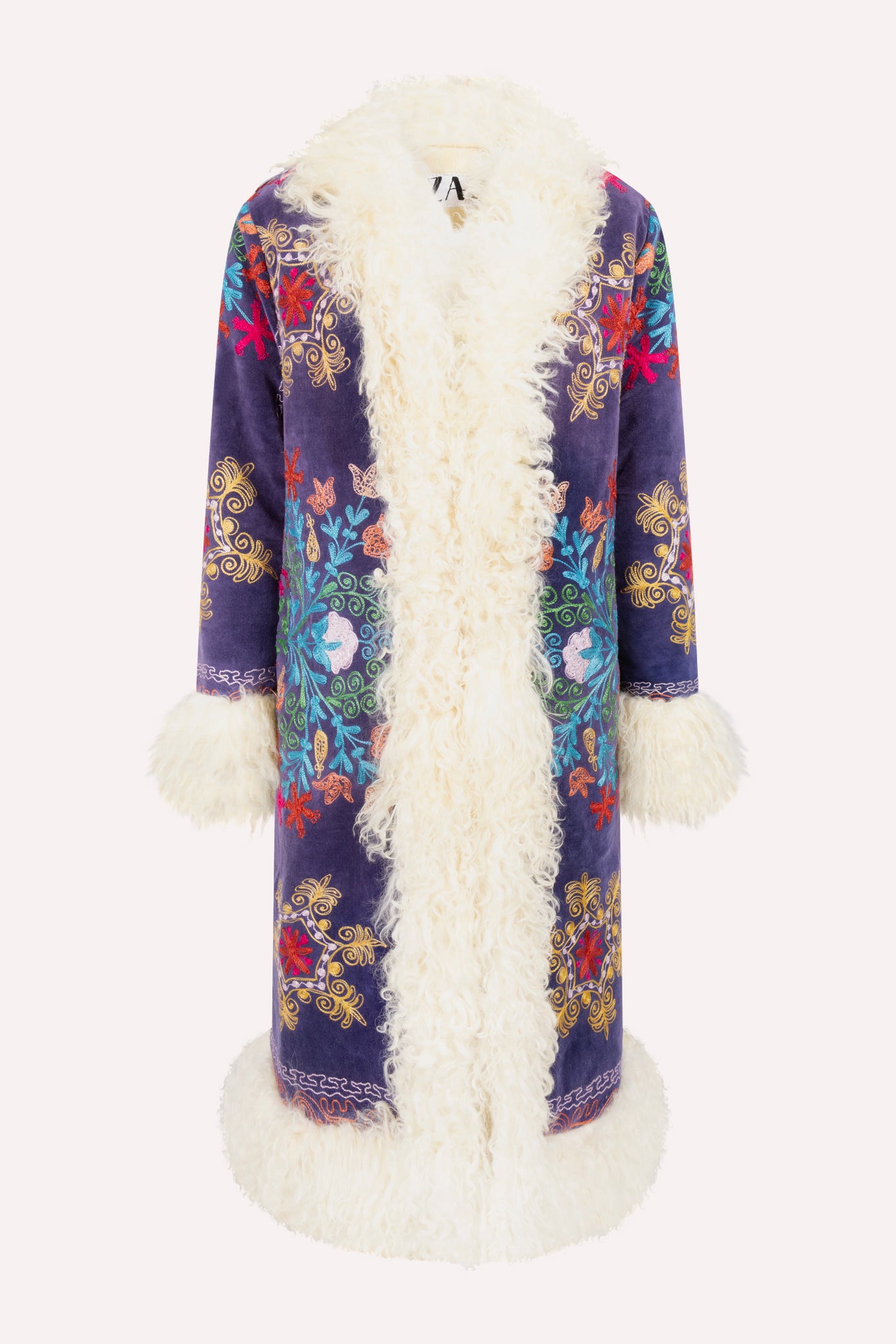 Handcrafted ZAZI Afghan coat made from vintage velours cotton suzani embroidery with upcycled sheepskin lining, featuring a straight 1970s-inspired silhouette with hook closures, created by women artisans in Afghanistan.