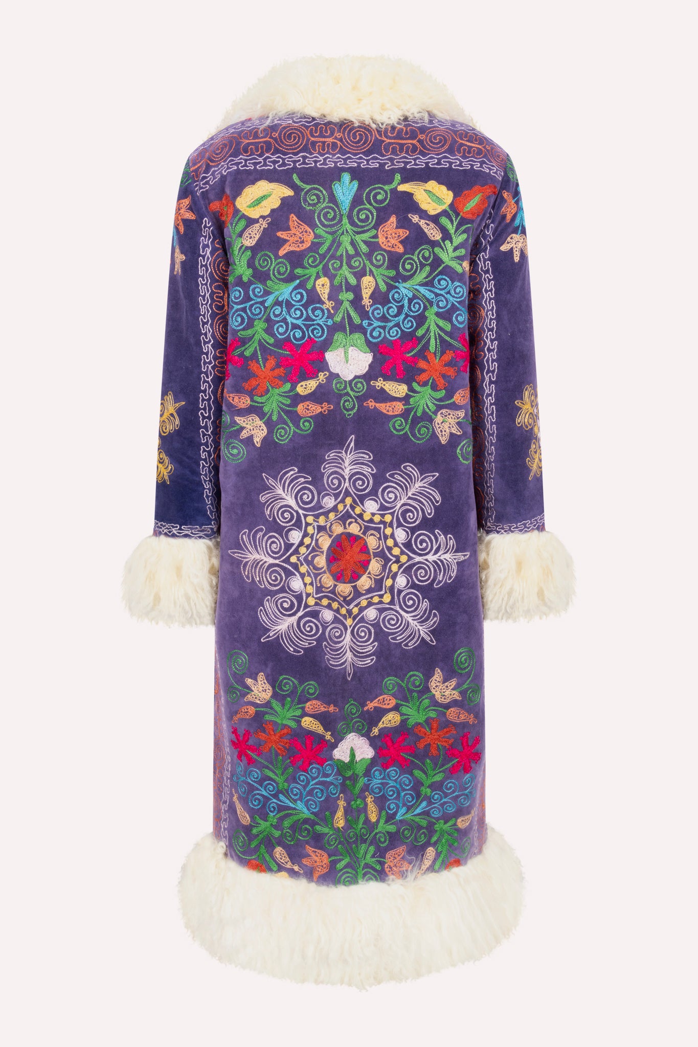 Handcrafted ZAZI Afghan coat made from vintage velours cotton suzani embroidery with upcycled sheepskin lining, featuring a straight 1970s-inspired silhouette with hook closures, created by women artisans in Afghanistan.