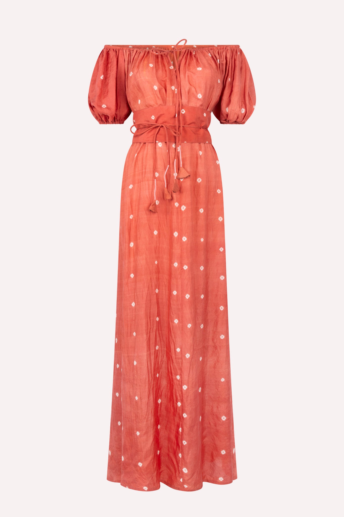 An off-shoulder, red maxi dress with white dots, naturally dyed silk, made in India. 