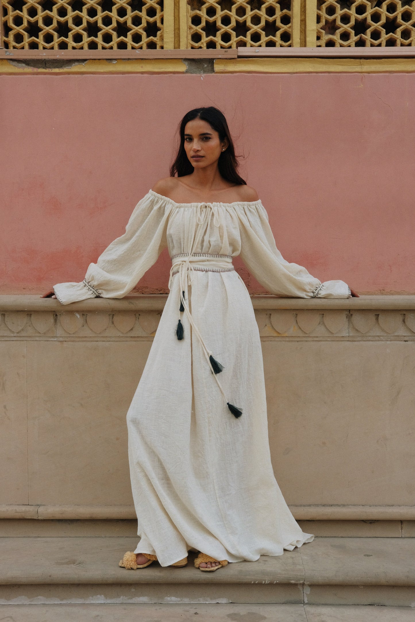 ZAZI Vayana Dress in handwoven Khadi cotton featuring a bohemian maxi silhouette, hand-embroidered details, versatile off-shoulder neckline, long sleeves, and matching belt.