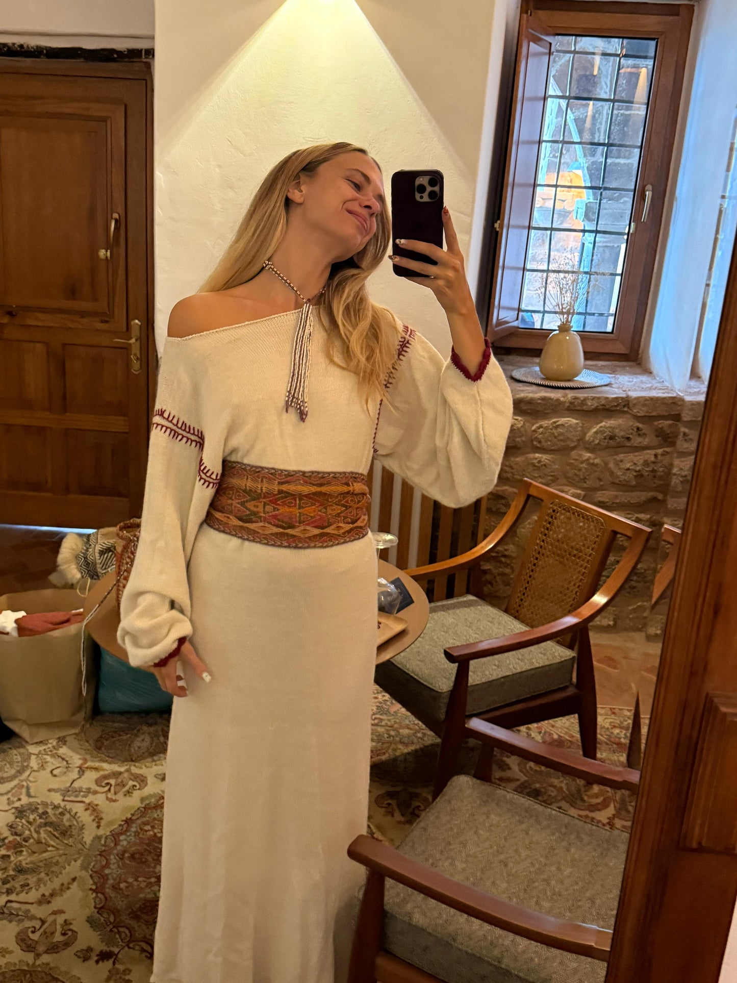 
                  
                    Handcrafted Peruvian alpaca wool maxi dress with crochet details, balloon sleeves, unique contrasting shoulder accent, and waist-accentuating belt.
                  
                