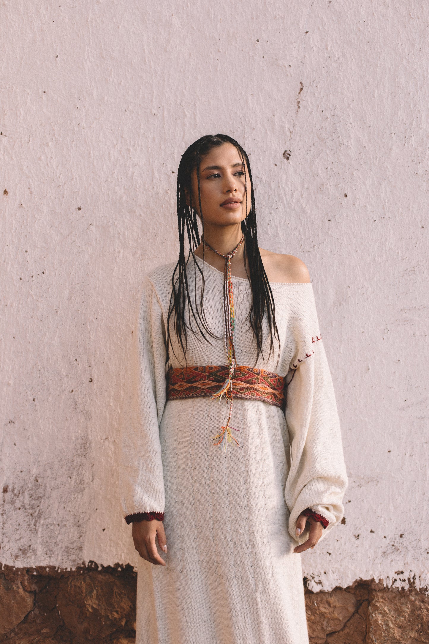 Handcrafted Peruvian alpaca wool maxi dress with crochet details, balloon sleeves, unique contrasting shoulder accent, and waist-accentuating belt.