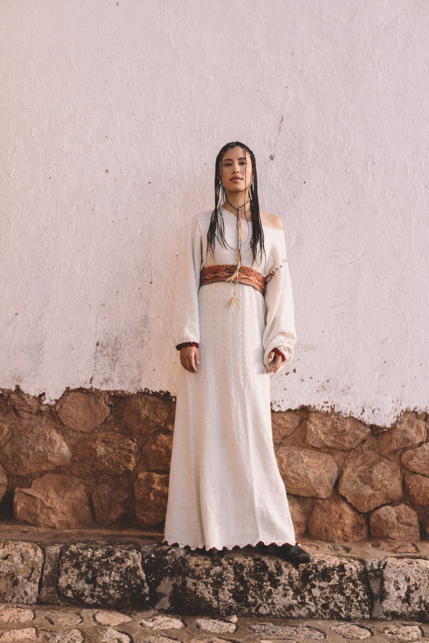 Handcrafted Peruvian alpaca wool maxi dress with crochet details, balloon sleeves, unique contrasting shoulder accent, and waist-accentuating belt.