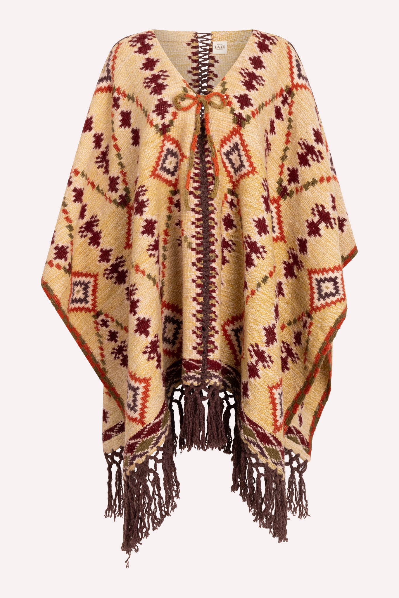 Handcrafted Himalayan wool poncho with tasselled hemline, crochet shoulder details, and adjustable ribbon neckline, designed by female artisans.